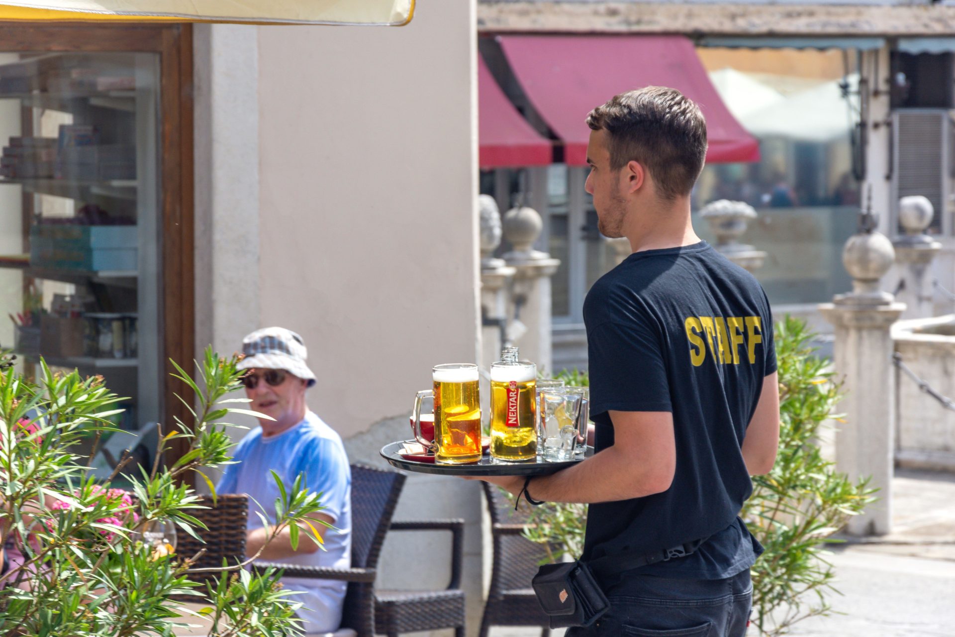 Young waiter with drinks, Gostilna Istrska Klaet Restaurant, Preseren Square, Koper, Slovene Istria, Slovenia