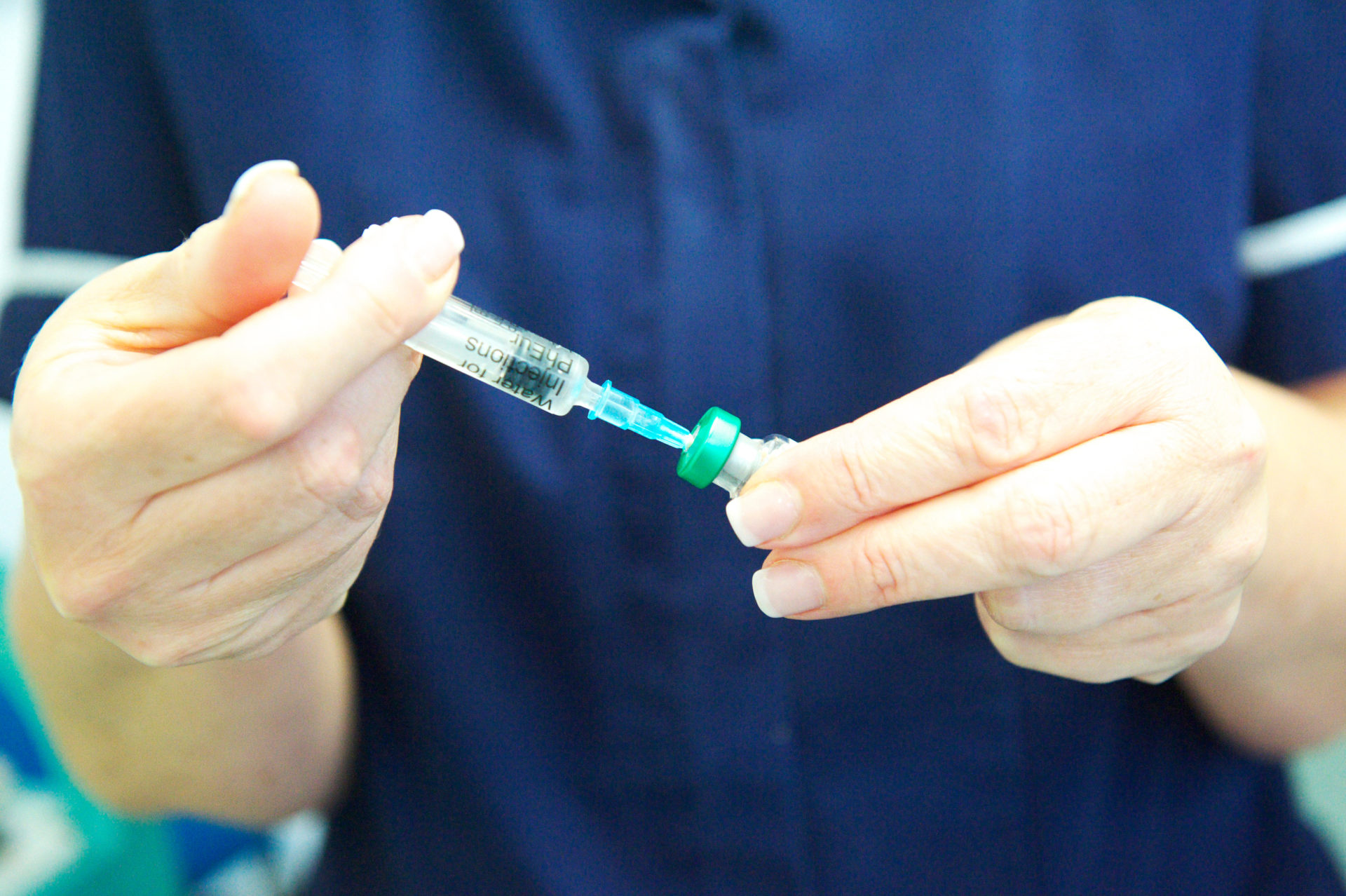 FHXF7F Nurse prepares MMR vaccine at GP health centre