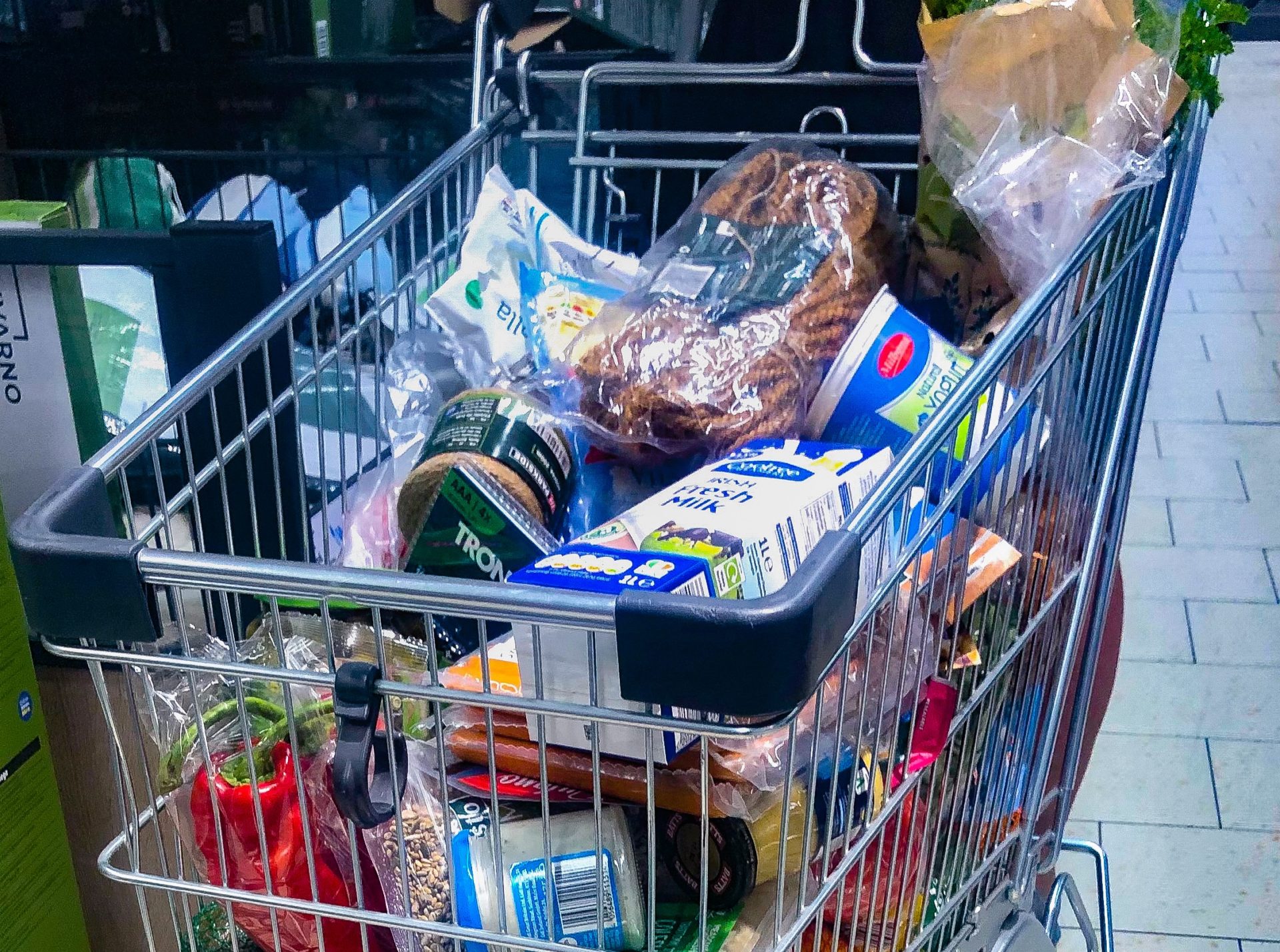 A shopping trolley full of groceries in a Lidl supermarket.