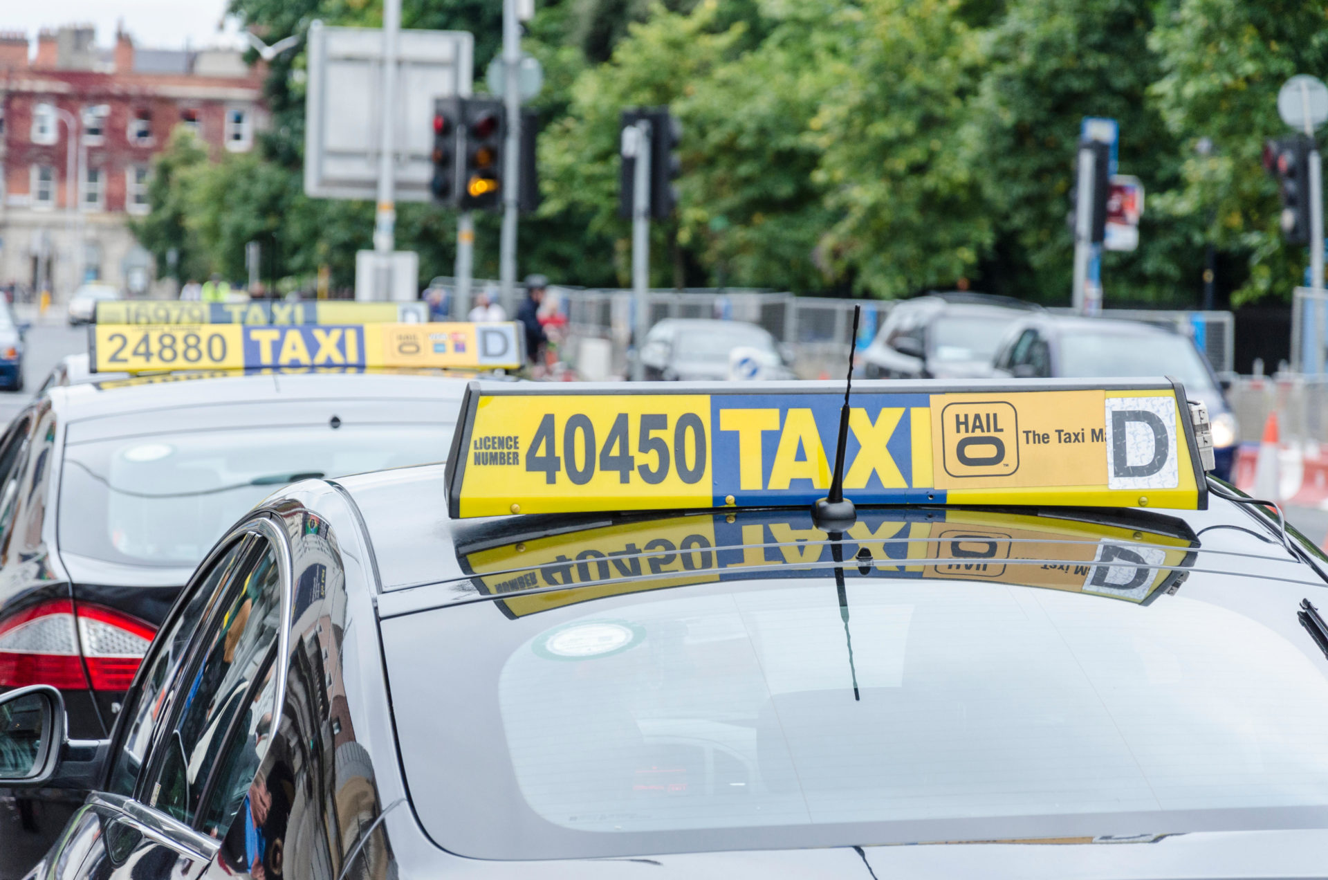 A row of taxis driving.