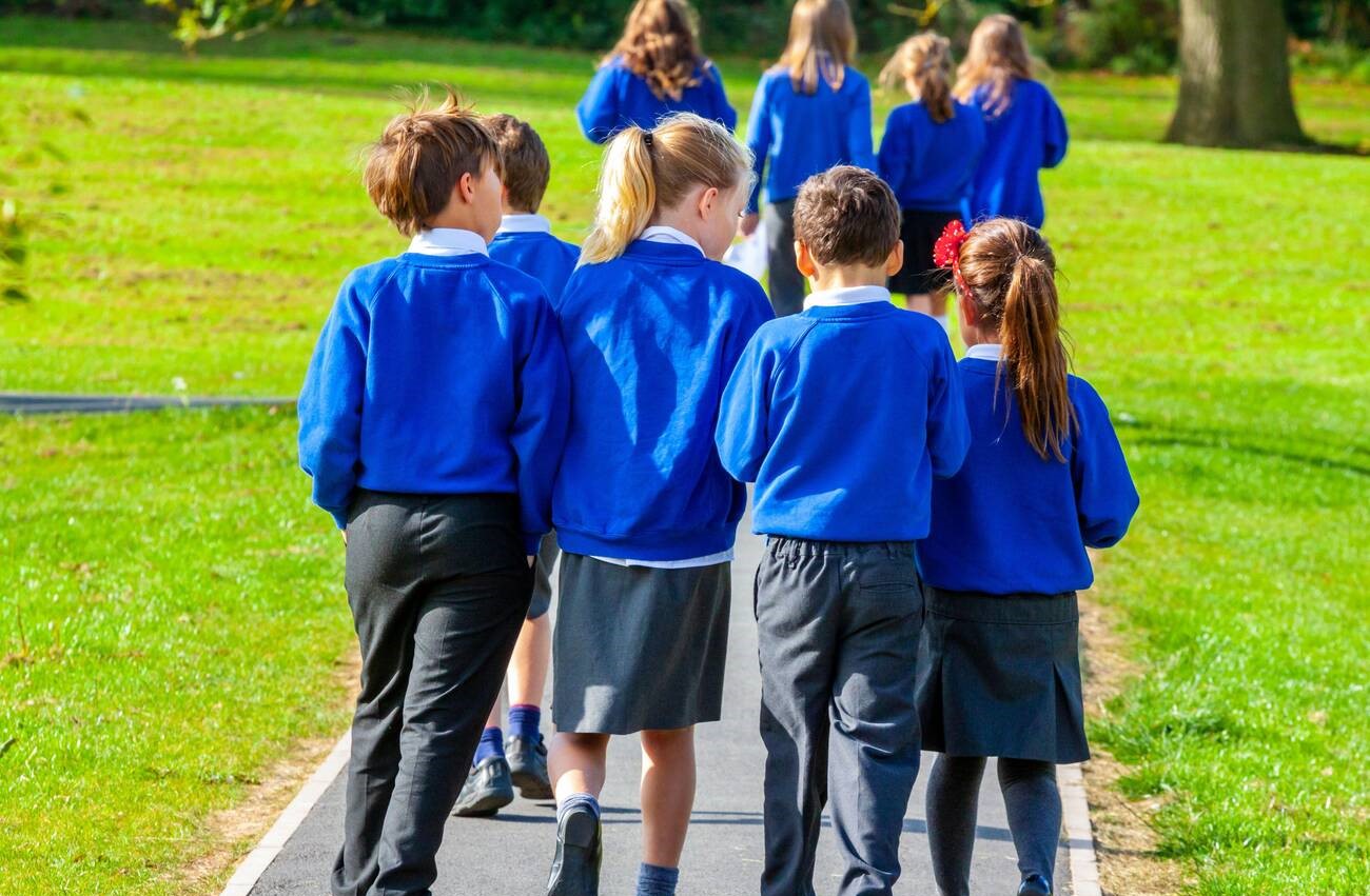 The Primary School Students Standing in Yard. Stock Image - Image