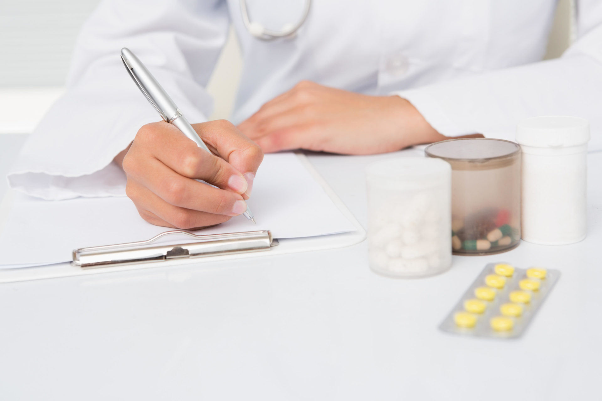 Doctor writing prescriptions
