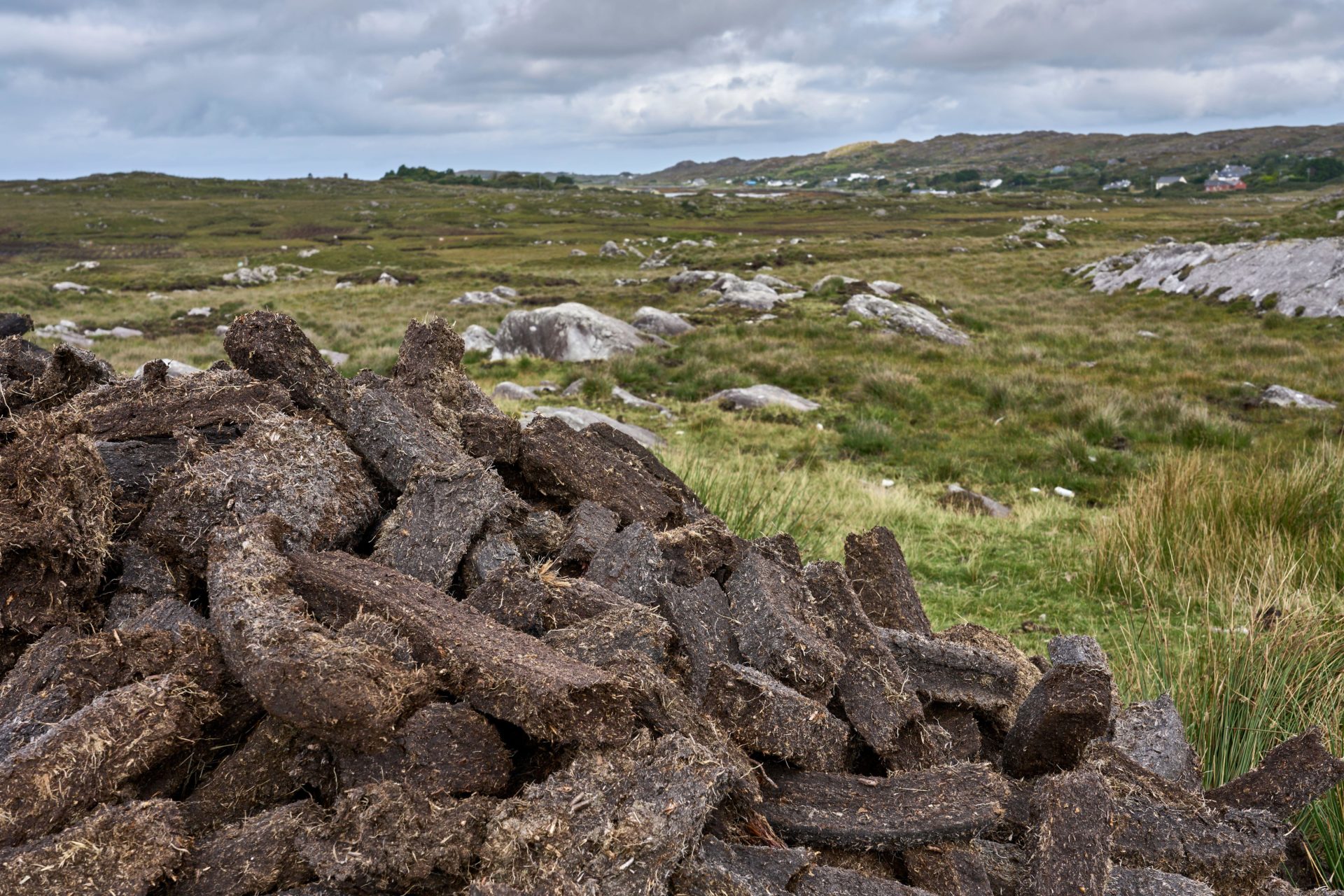 A large pile of peat turf cut on Irish farmland