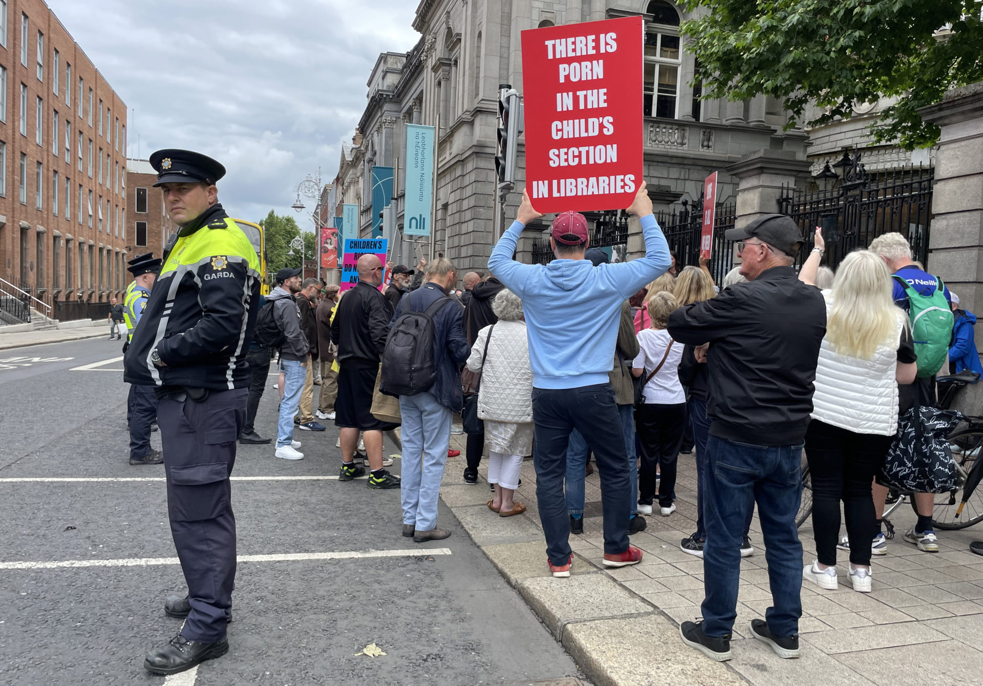 Protest outside the Dáil against the SPHE curriculum, with a sign saying "there is porn in the child's section in libraries".