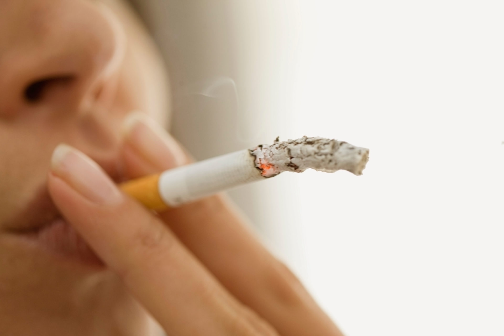Close up of woman smoking cigarette.