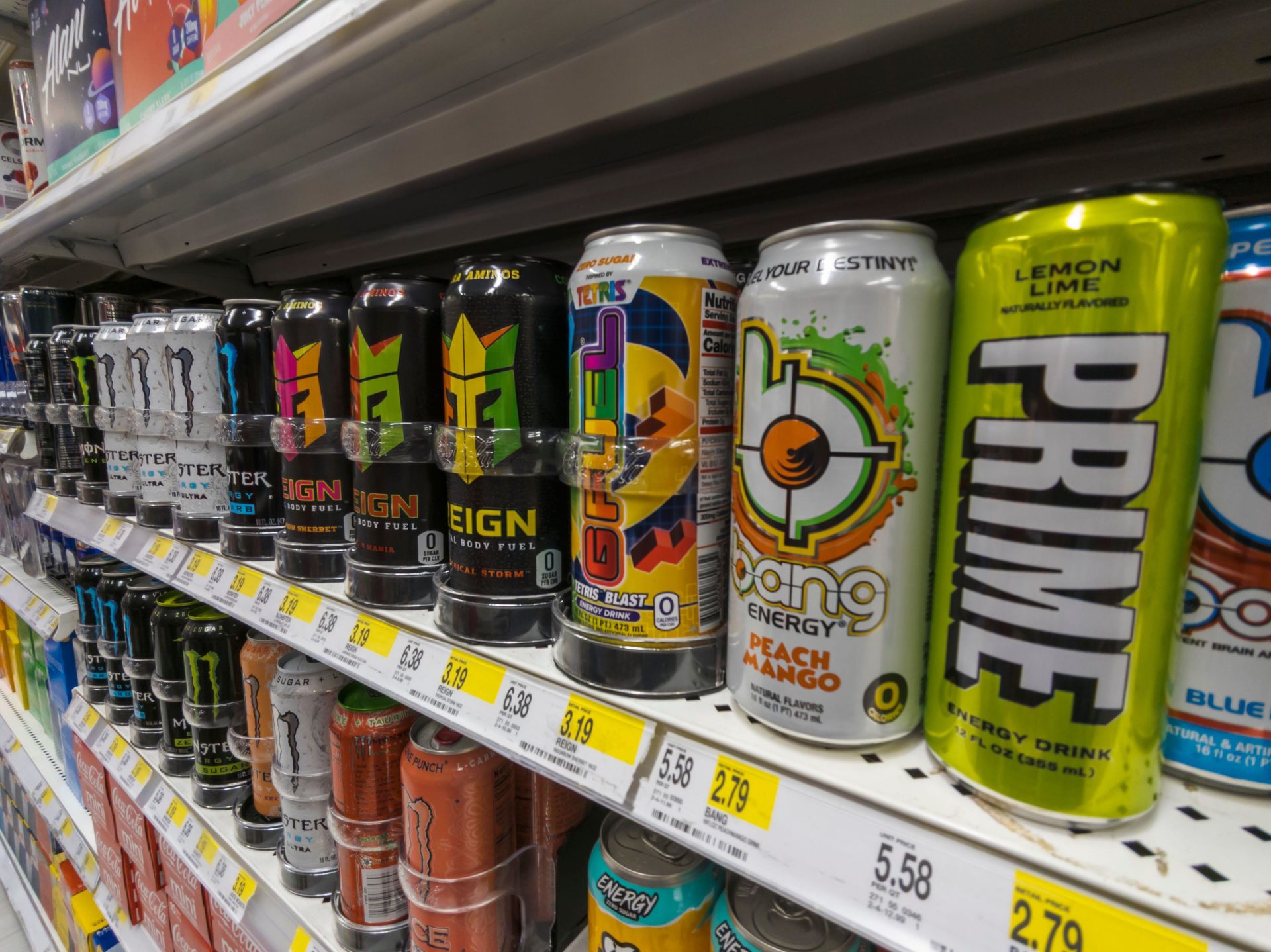 A selection of energy drinks in a shop, including Prime Energy.
