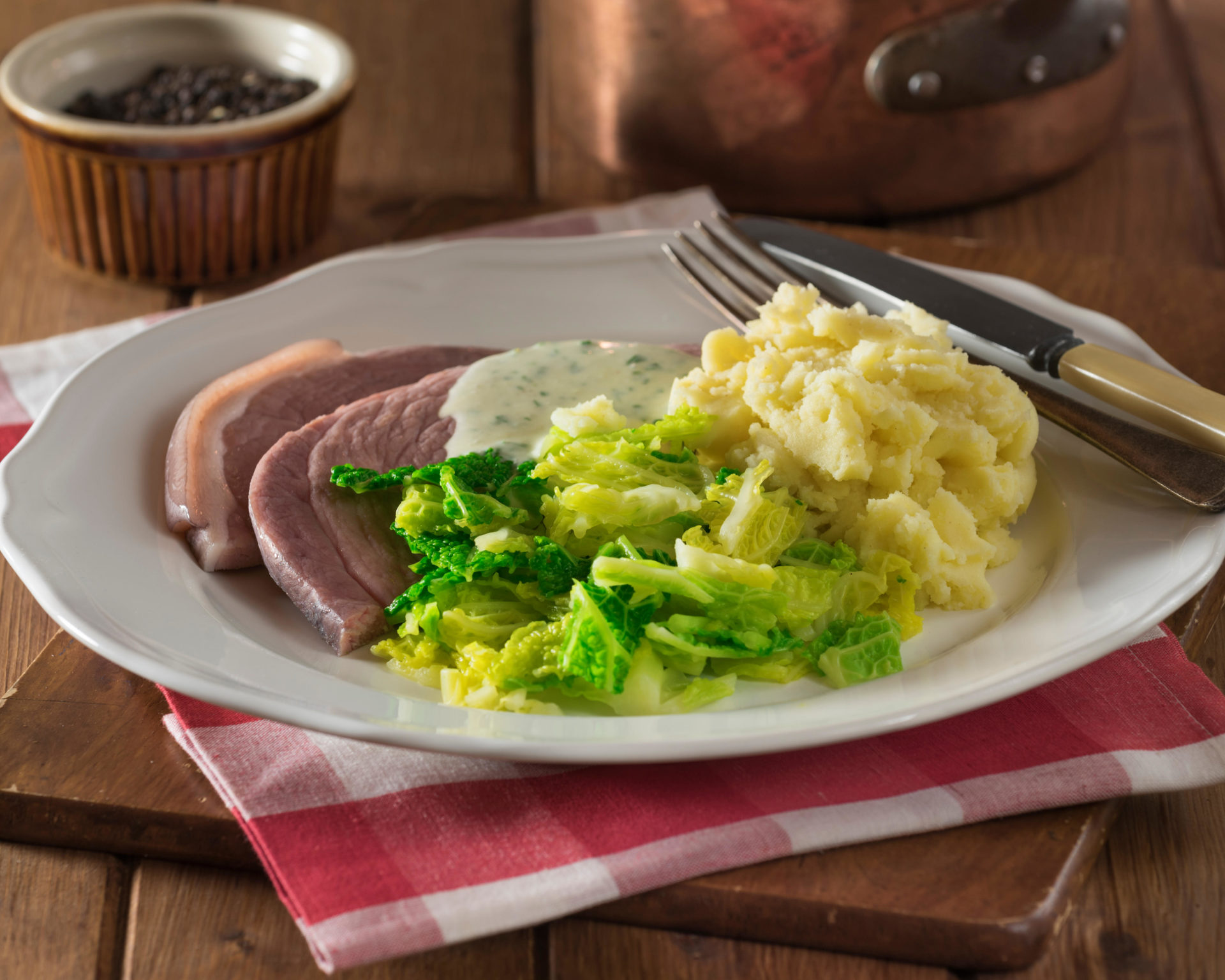 Irish bacon and cabbage with parsley sauce.