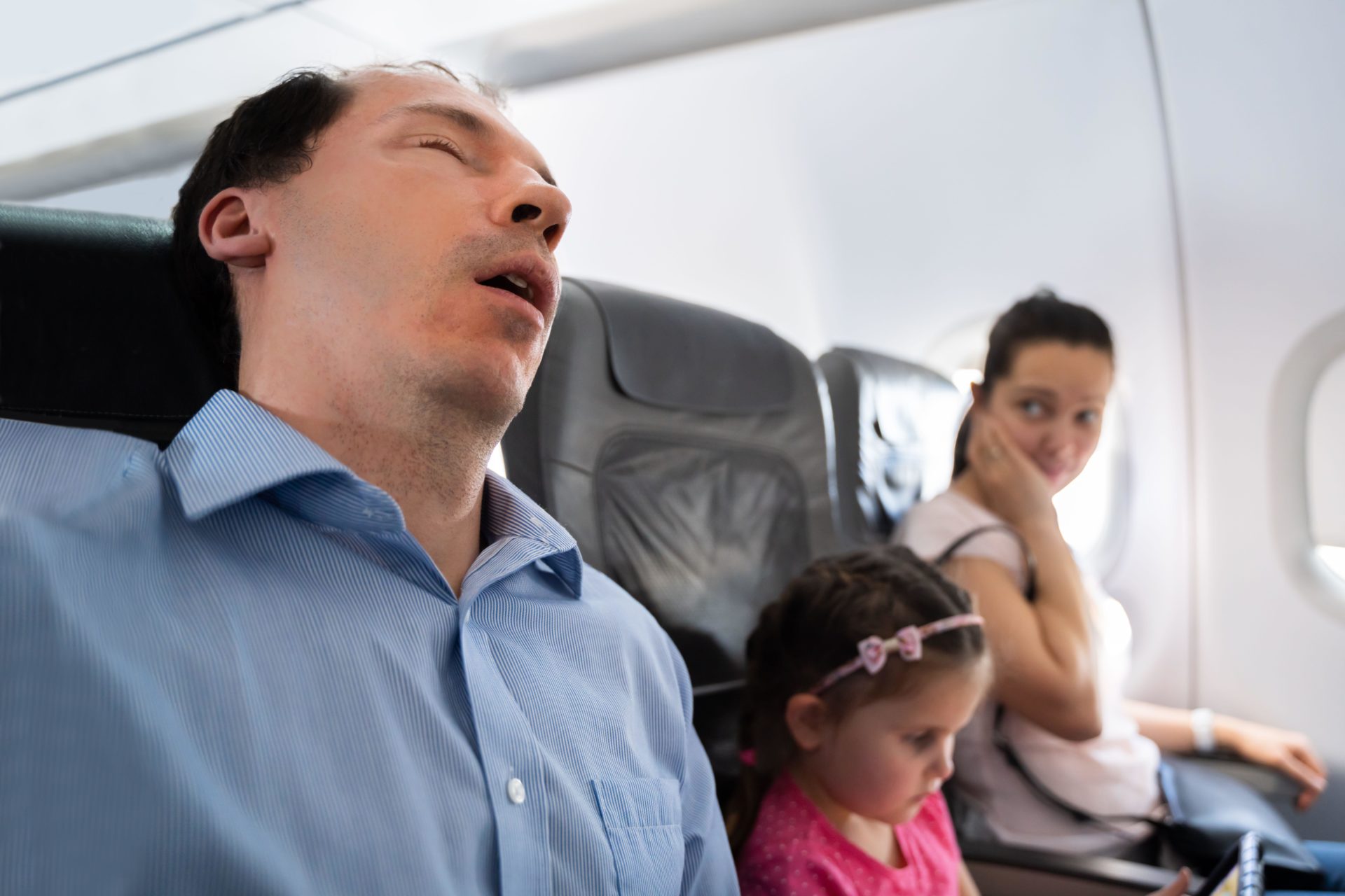 Man snoring loudly on plane