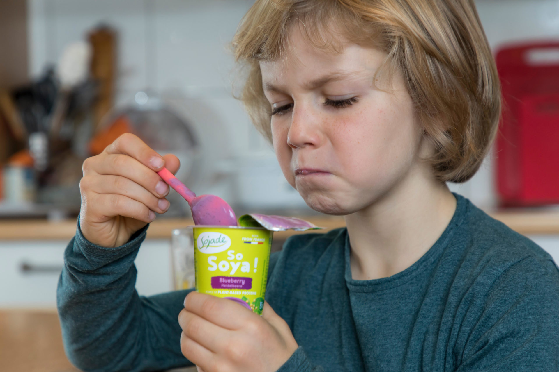 Boy, 7 years old, tastes vegan food, soy fruit yogurt substitute 