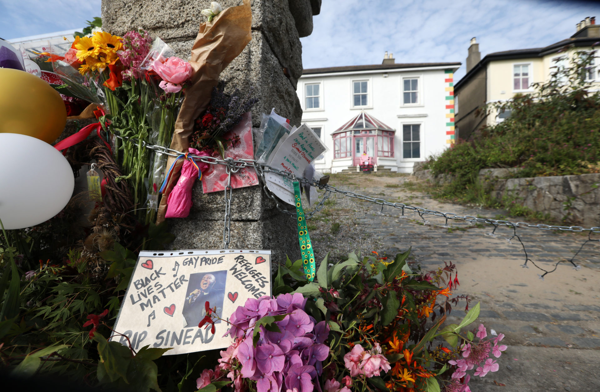 Flowers are left outside Sinéad O’Connor's former home in Bray on the morning of her funeral