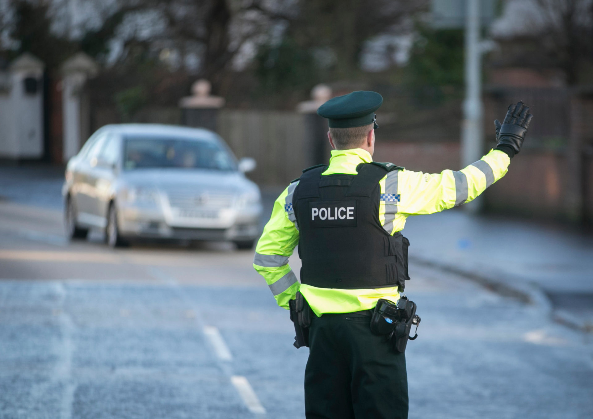 A PSNI Road Policing officer flags down oncoming drivers