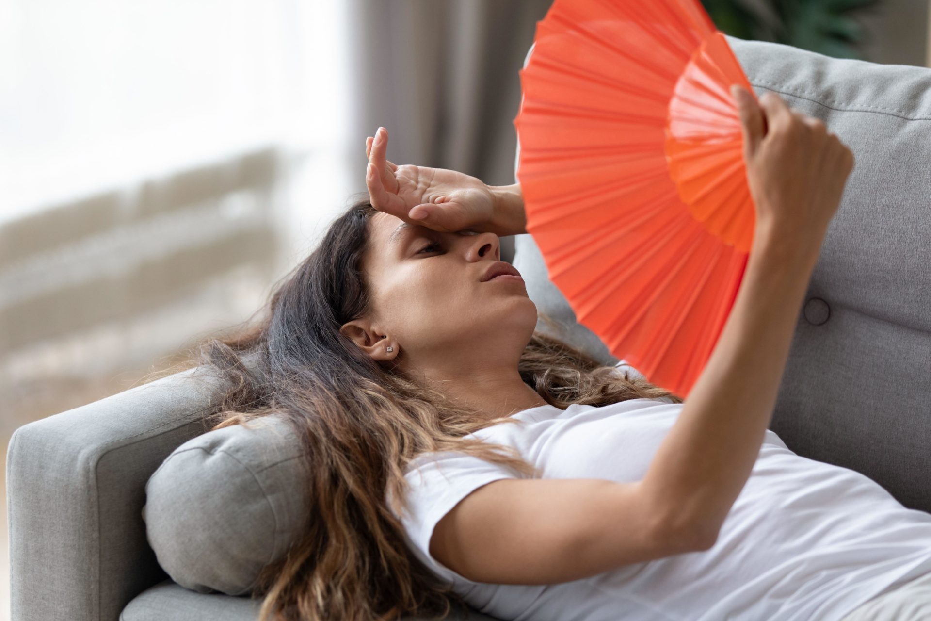 Woman using hand fan 