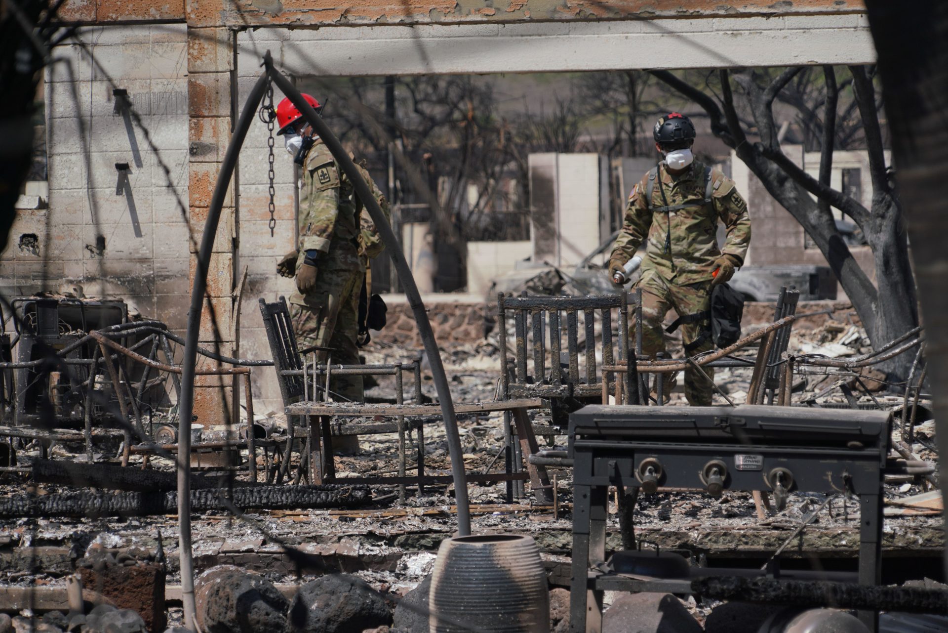 Hawaii Army National Guard SAR soldiers search the remains of burnt out homes in the aftermath of wildfires that destroyed most of the historic town,