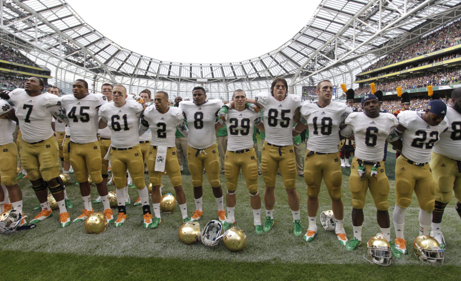 Notre Dame players pose after the final whistle of their NCAA college football game against Navy, in Dublin,