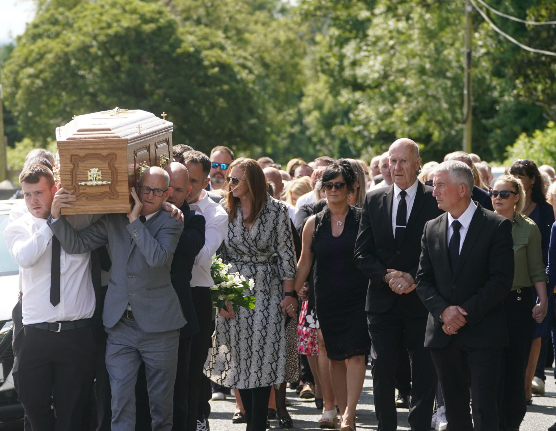 Family members and mourners follow as the coffin of Brendan Wall is carried from the Church of St Brigid in Grangegeeth, Co. Meath