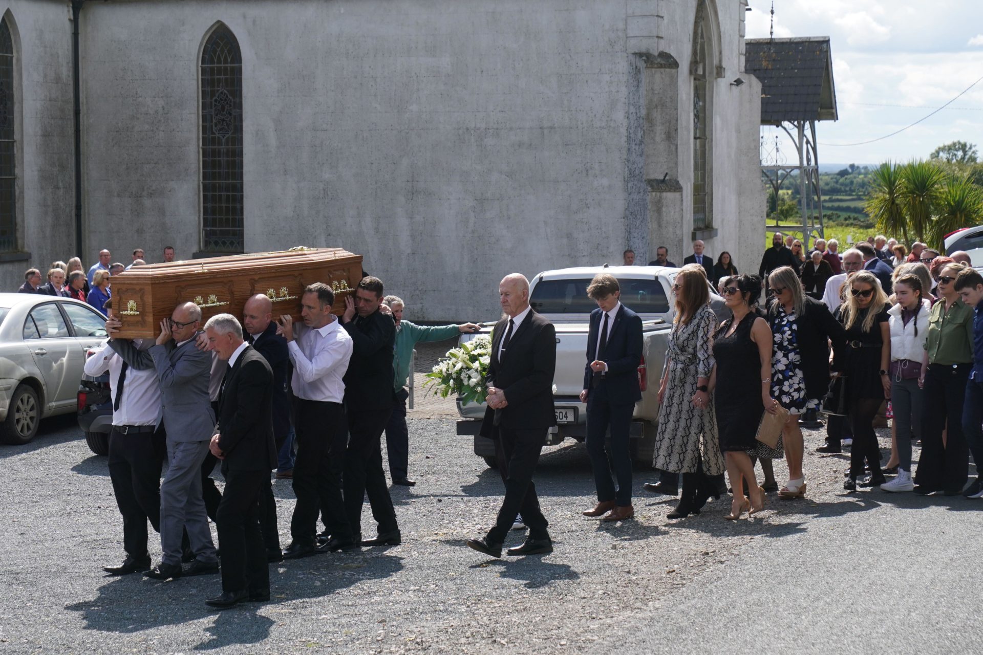Family members and mourners follow as the coffin of Brendan Wall is carried from the Church of St Brigid in Grangegeeth, Co. Meath