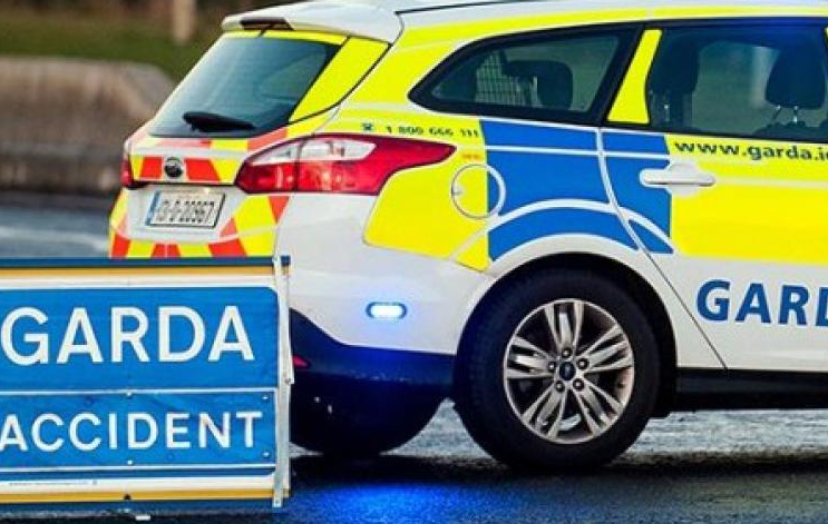 A car crash. Image shows a Garda car beside a smaller sign. It has the words "Garda accident" in white font on a blue background)