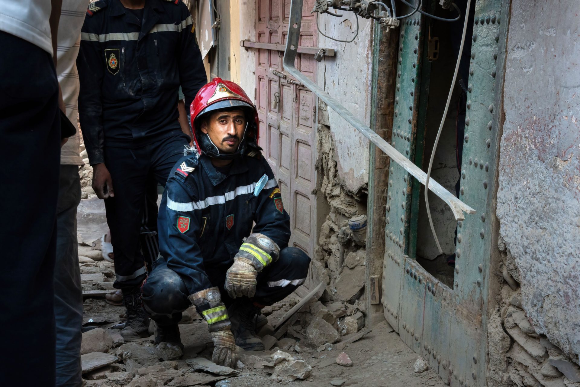 A fireman rests outside a collapsed house where they were searching for bodies under the rubble in the city of Amizmiz, Morocco following the earthquake.