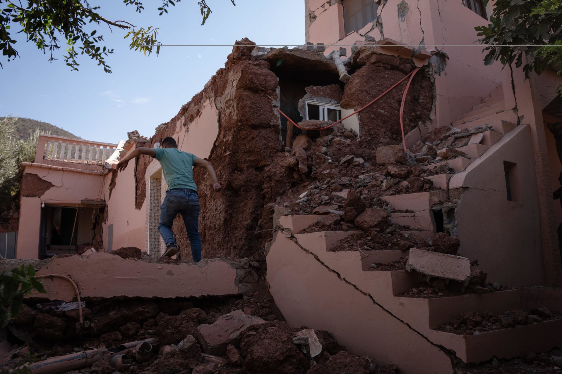 Man is seen climbing back to his destroyed house in Morocco