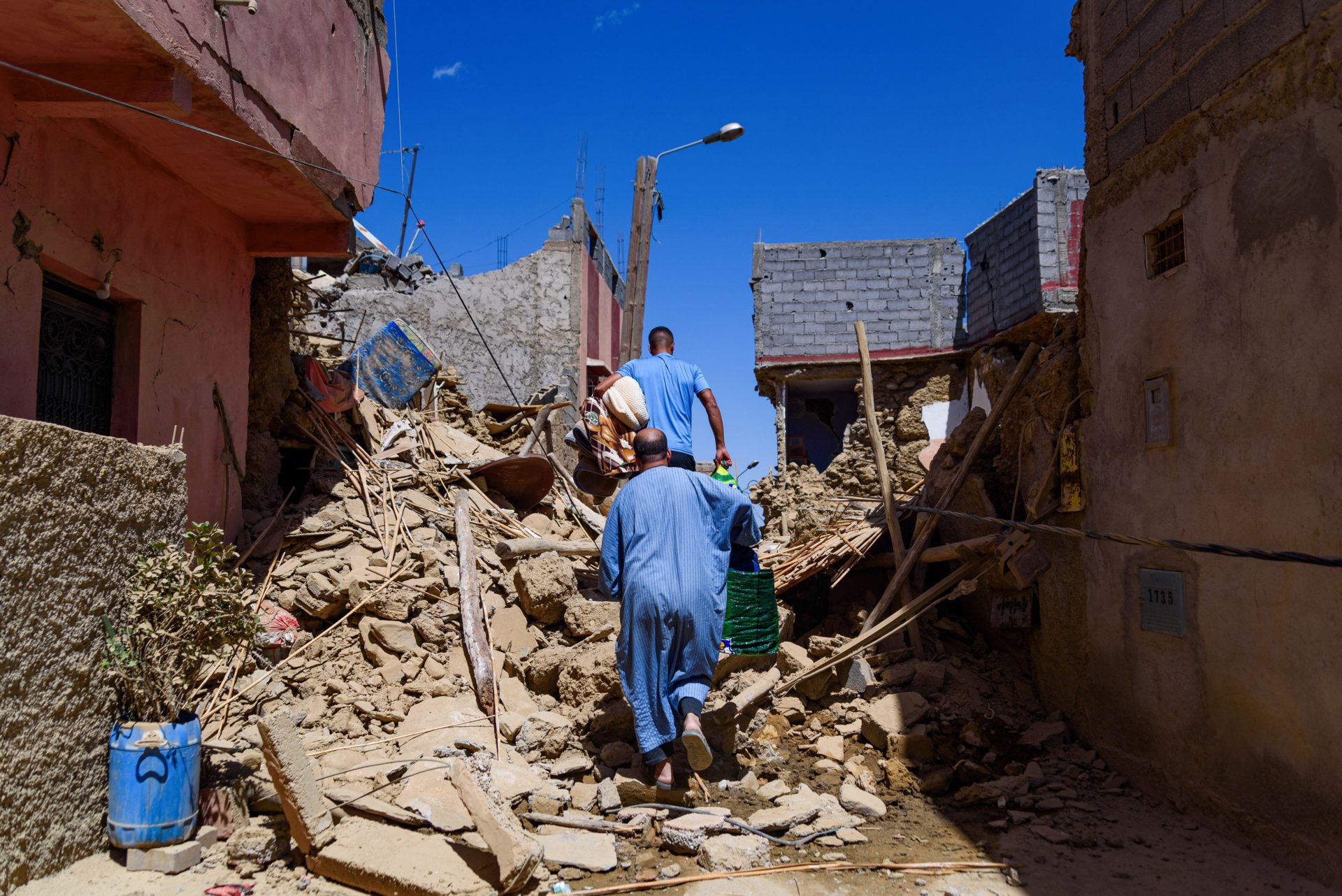 A man walking among debris from destroyed houses in the aftermath of the earthquake. 