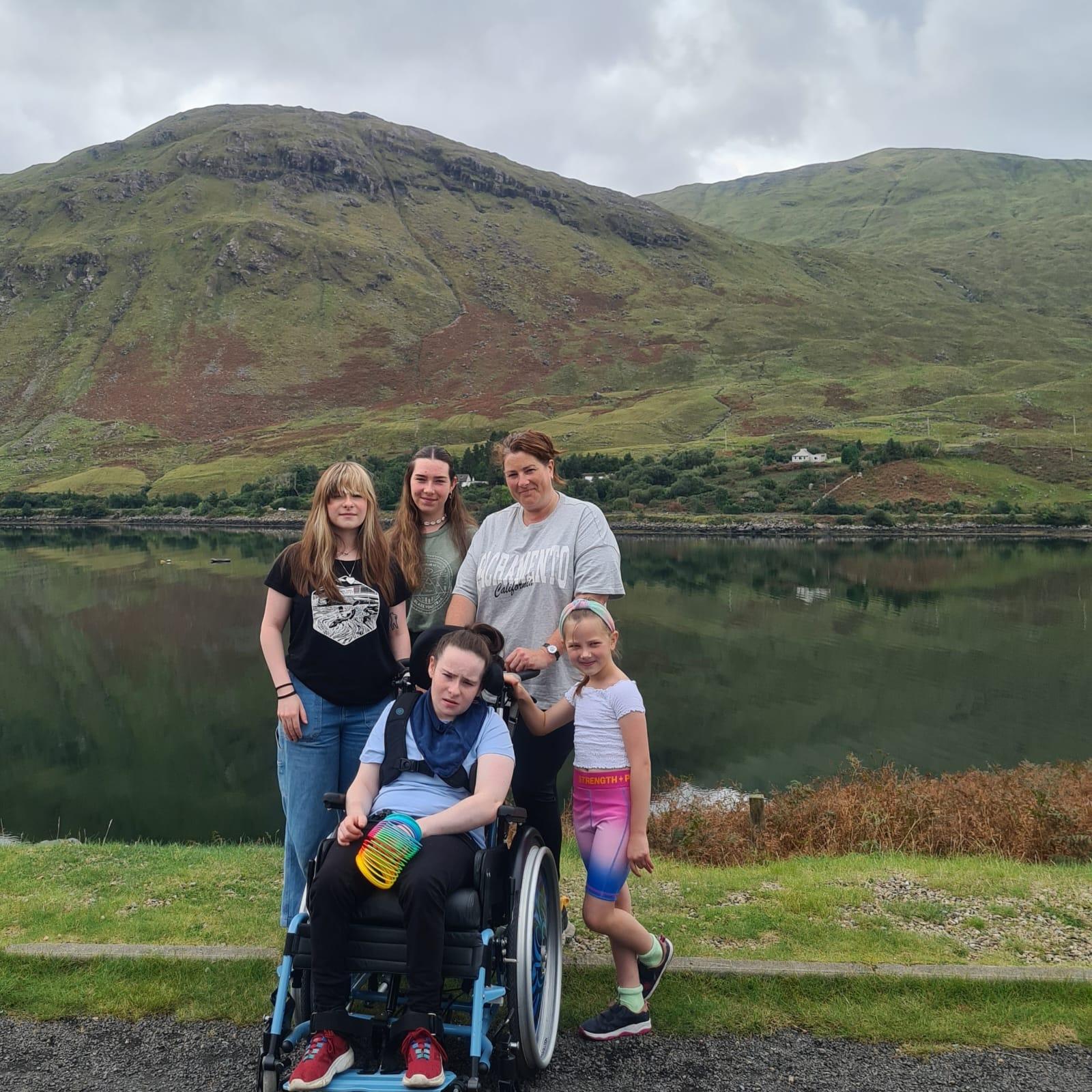 Lorraine Dempsey and her daughters on Sunday in front of Búcán Mountain
