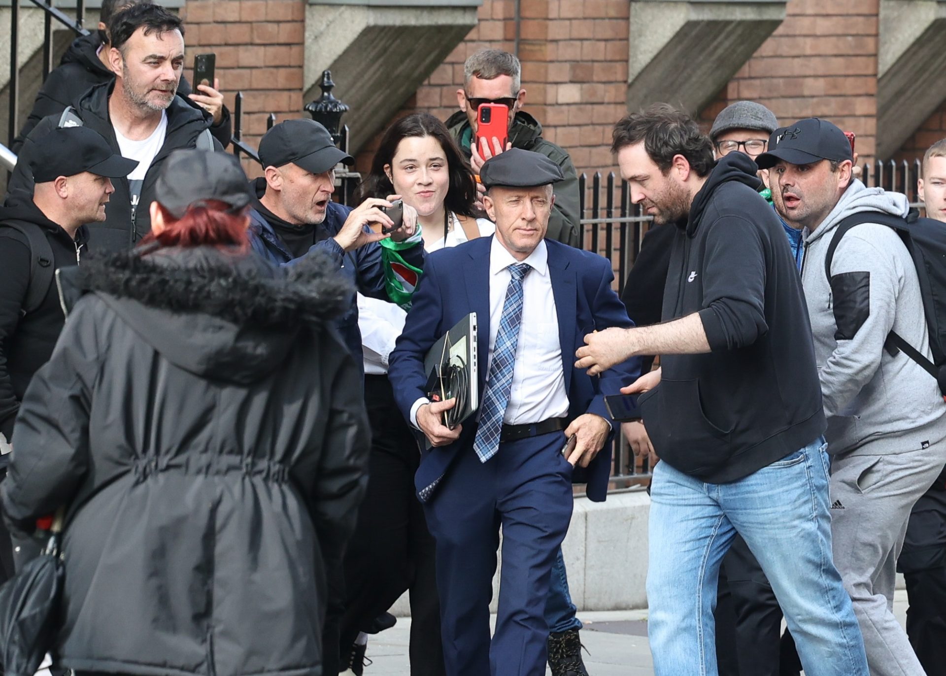 TD Michael Healy-Rae and his assistant are surrounded by protestors as he enters Leinster House