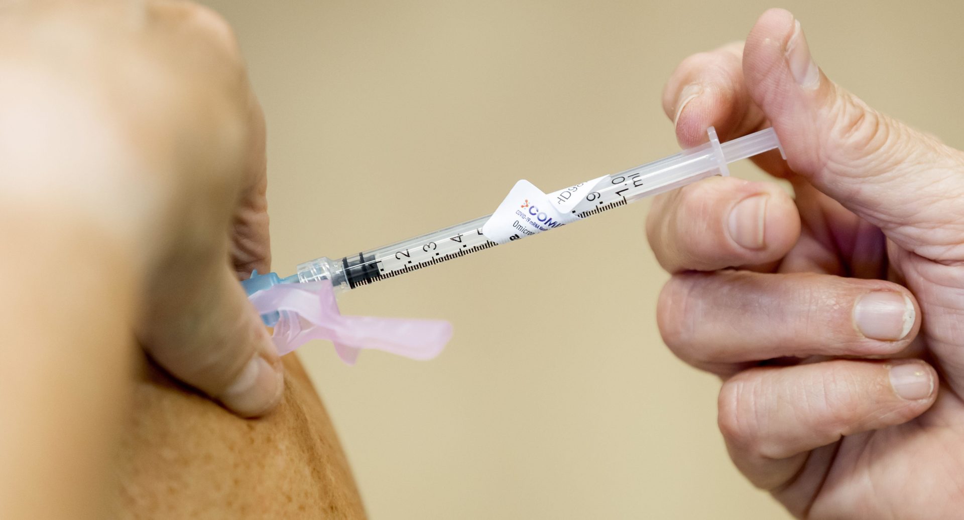 A person is administered the COVID vaccine.