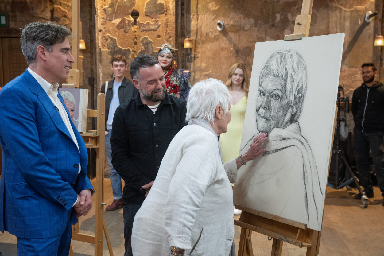 Judi Dench inspects Gareth Reid's portrait of her as part of the 'Portrait Artist of the Decade' competition in May 2023. 