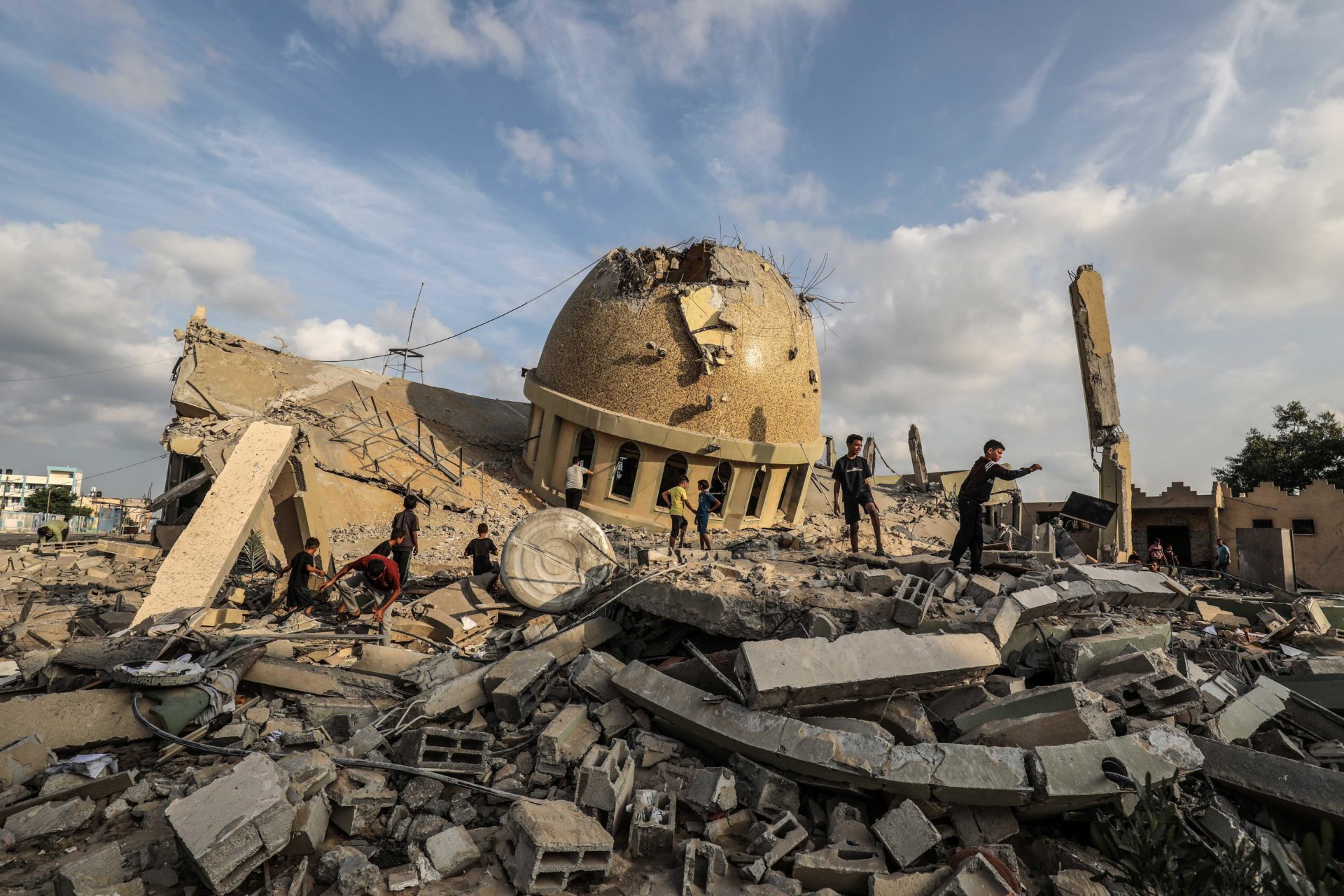 Palestinians inspect the ruins of a destroyed mosque in the city of Khan Yunis, south of the Gaza Strip, following an Israeli airstrike