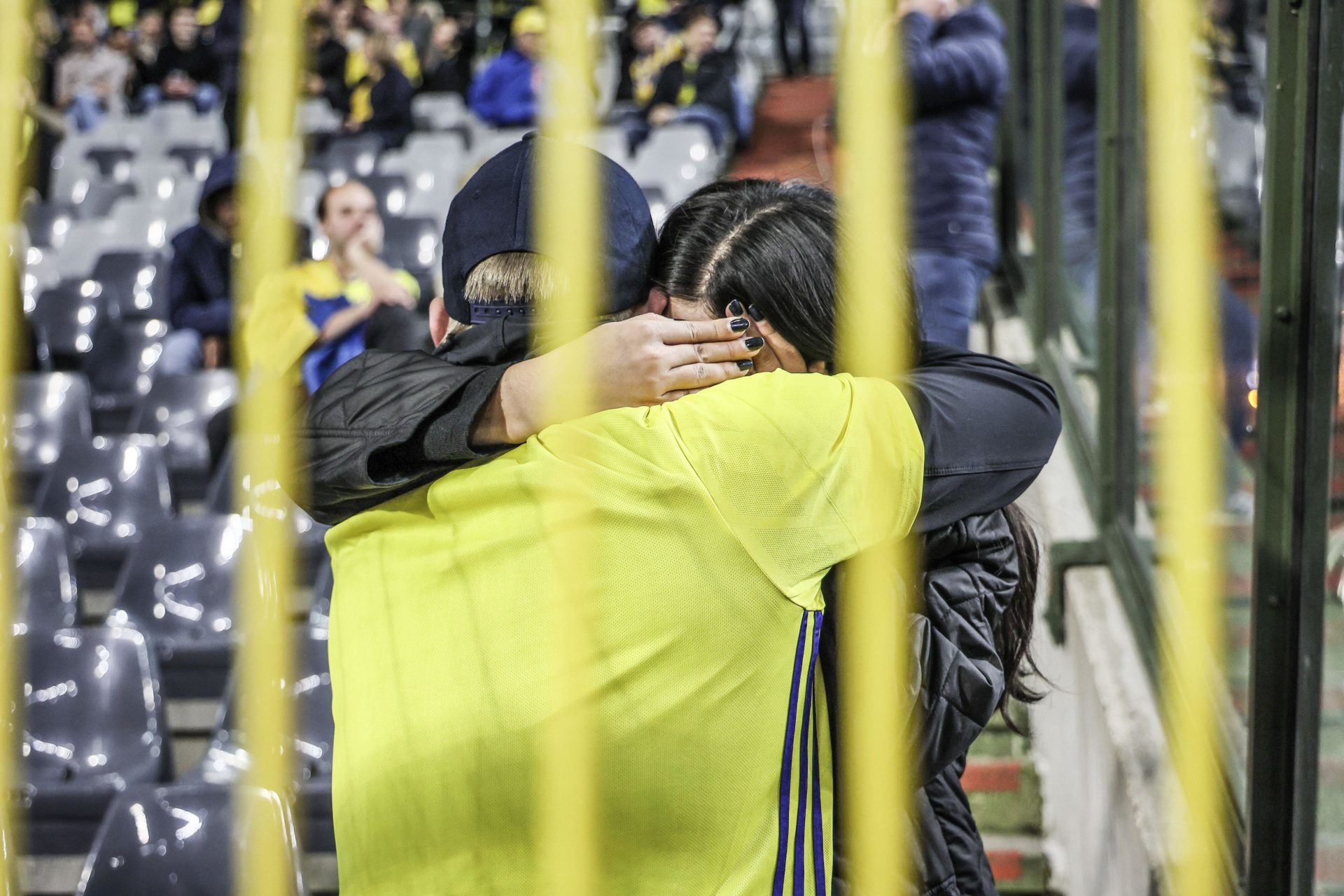 Sweden's supporters comfort each other during the suspended match between Belgium and Sweden