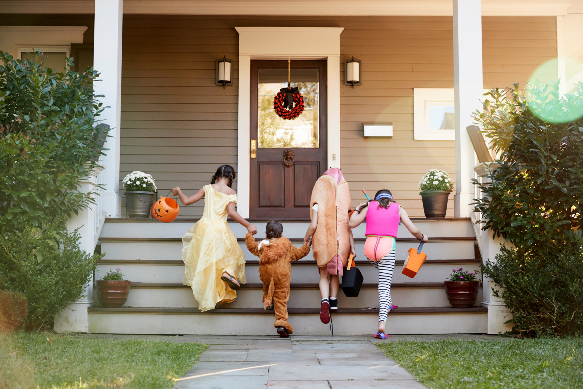 Children Wearing Halloween Costumes For Trick Or Treating.