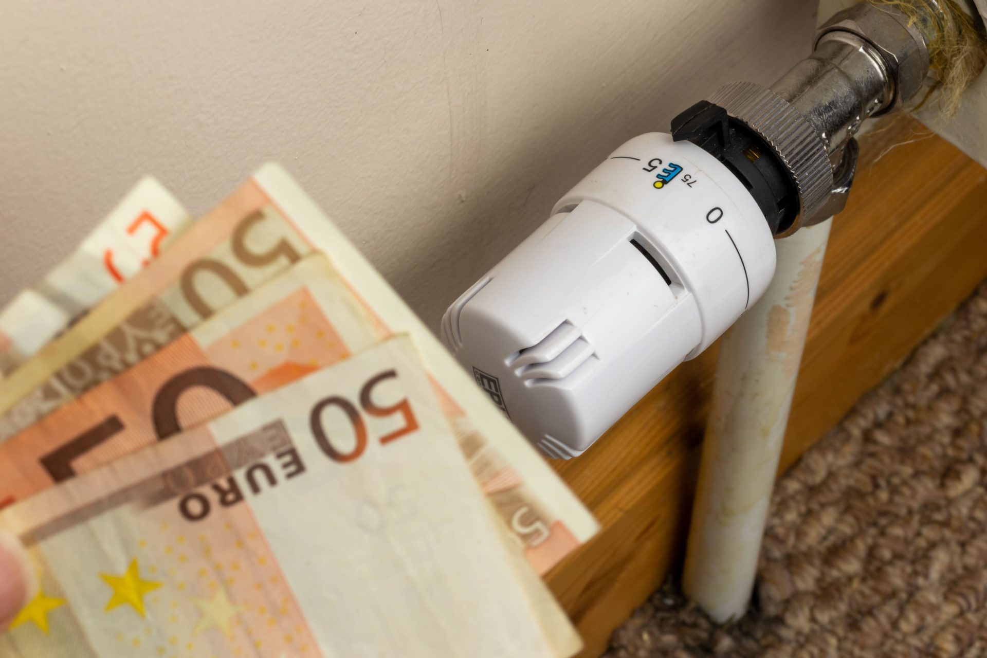 Euro banknotes beside a radiator.