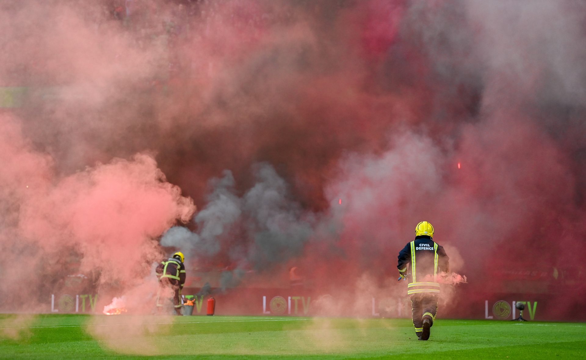 Members of the Fire Brigade clear the flares from the pitch before the FAI Cup Final between St Pats and Bohs