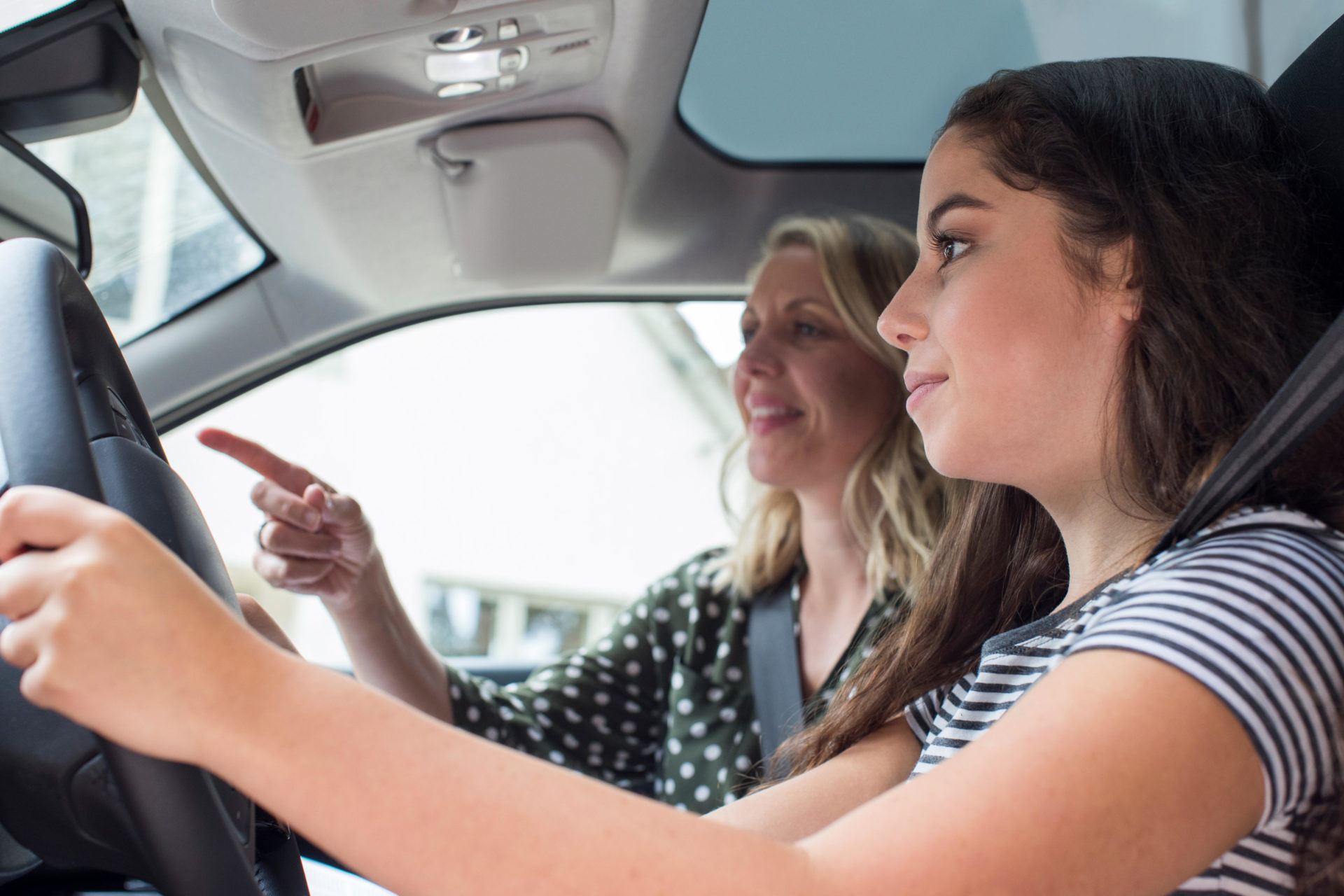 Teenager with license driving car with adult sitting in passenger seat. Image: Daisy-Daisy / Alamy Stock Photo