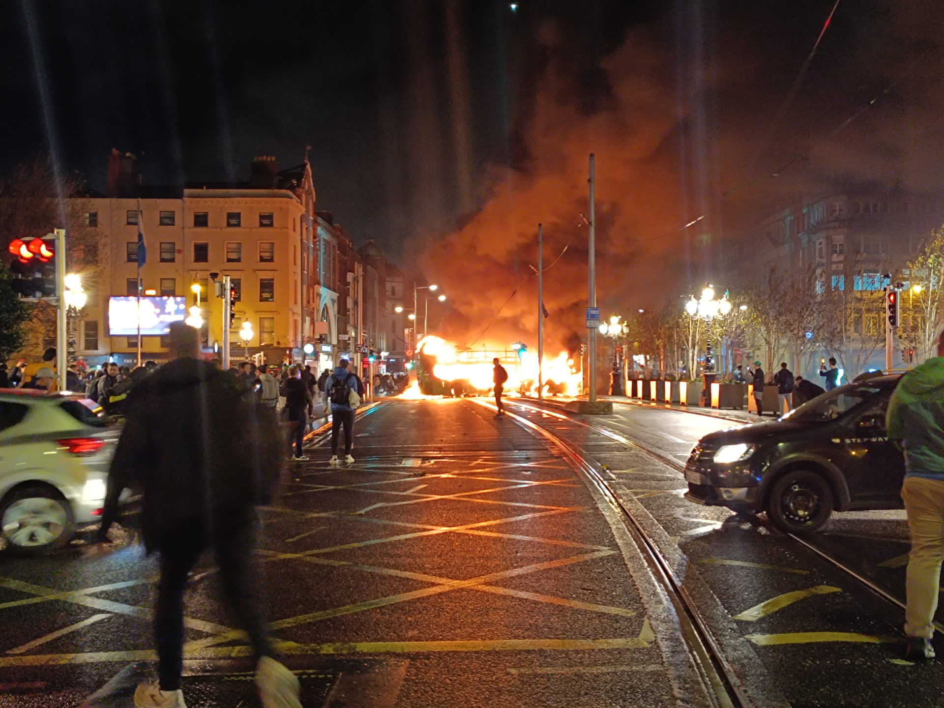 A bus burns just off O'Connell Street Bridge in Dublin