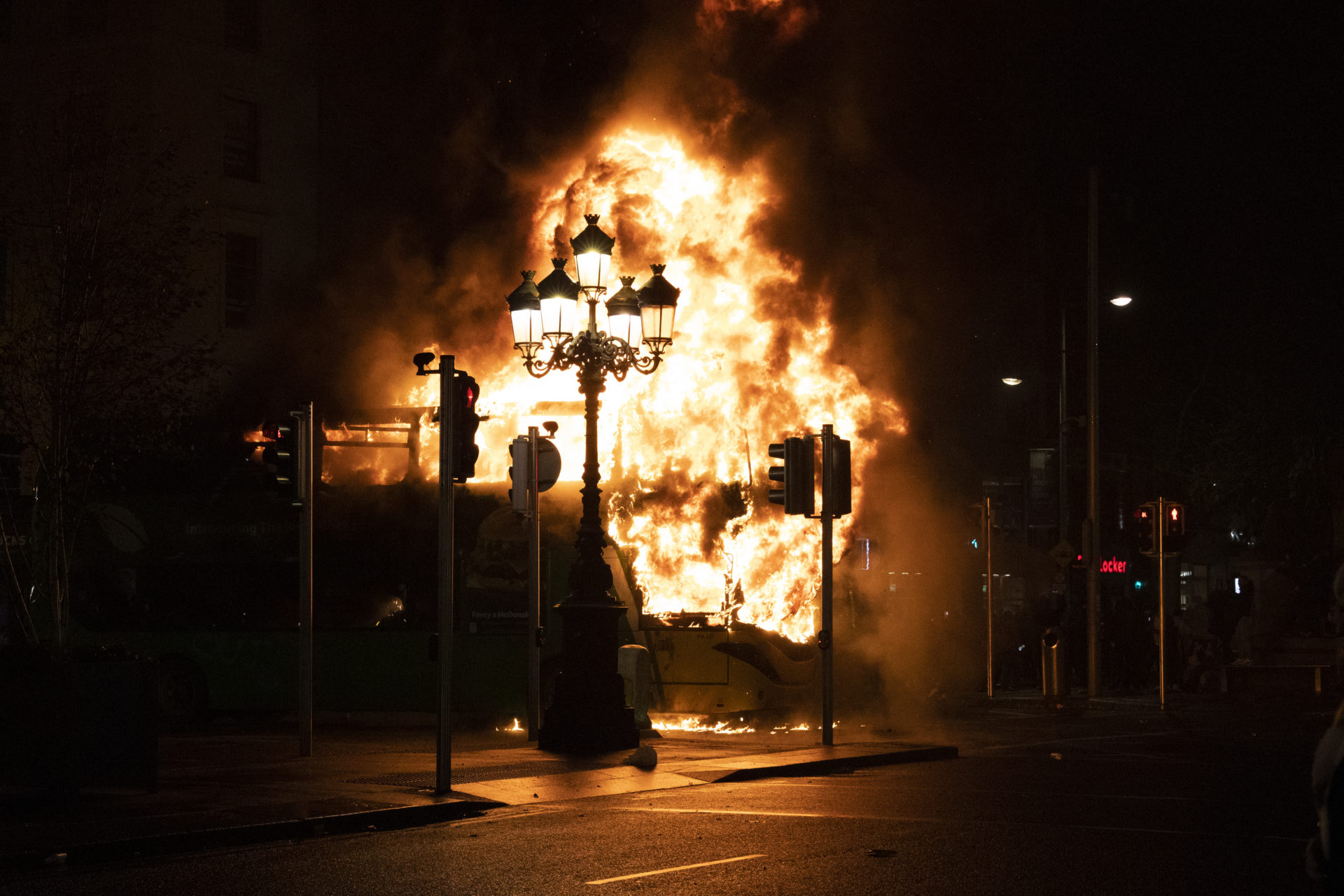 A double decker bus and a car are set alight on the edge of O’Connell Bridge during riots in Dublin