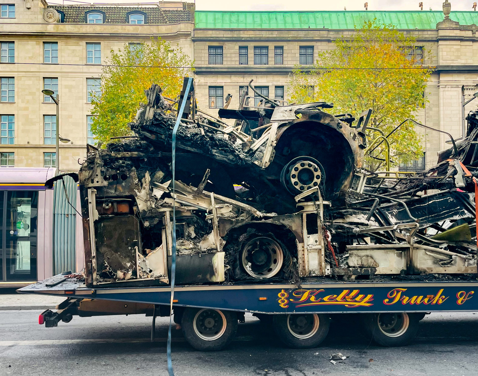 The remains of a burned bus being transported on O'Connell Street following riots, 24/11/2023. Photograph: Leon Farrell / © RollingNews.ie