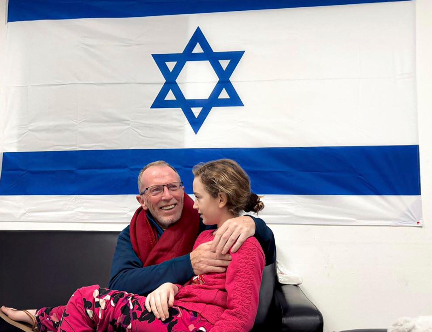 In this photo provided by the Israeli Army, Emily Hand reunites with her father Thomas, 26-11-23. 