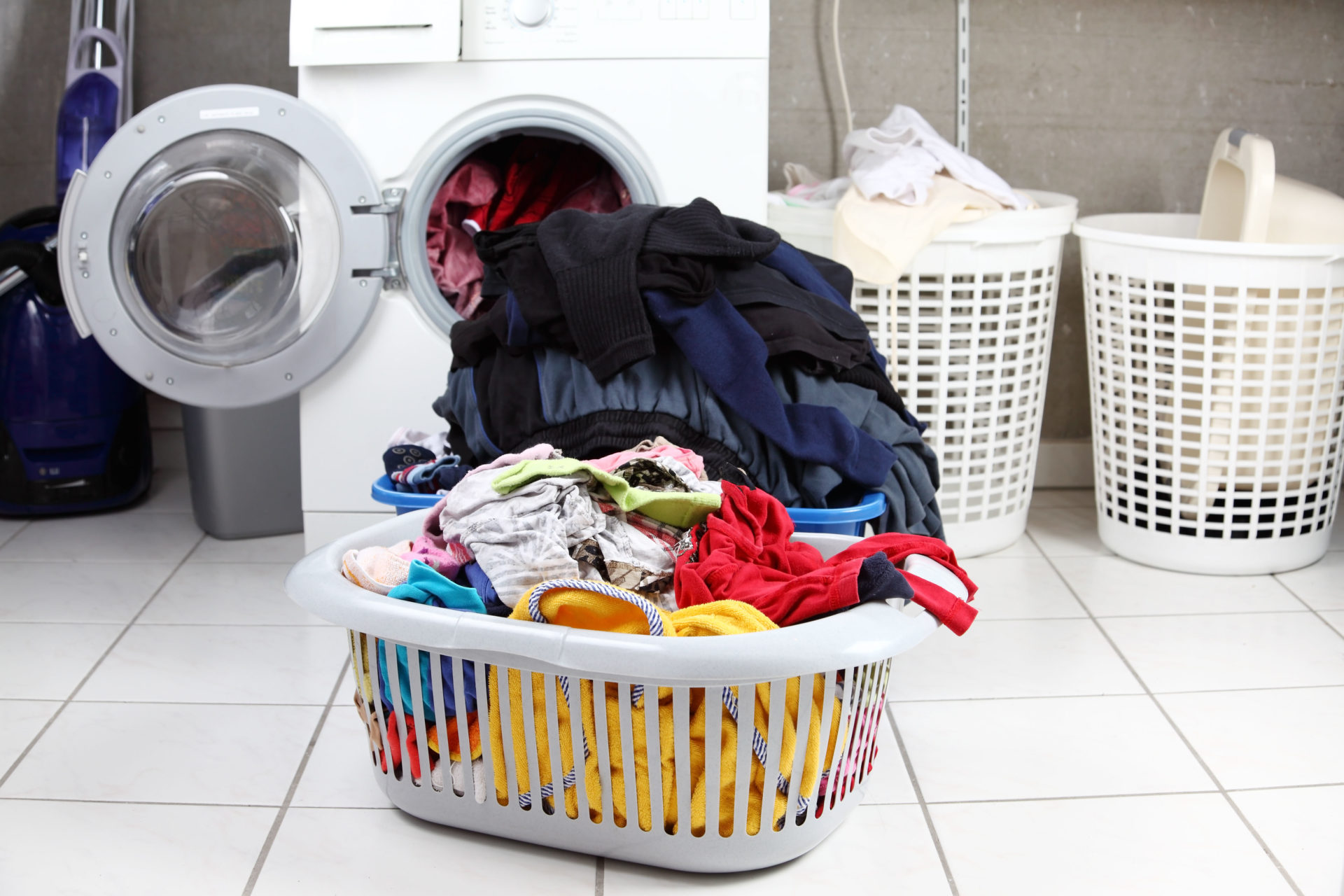 Two baskets of dirty laundry in the washing room, including shirts, trousers and underwear.