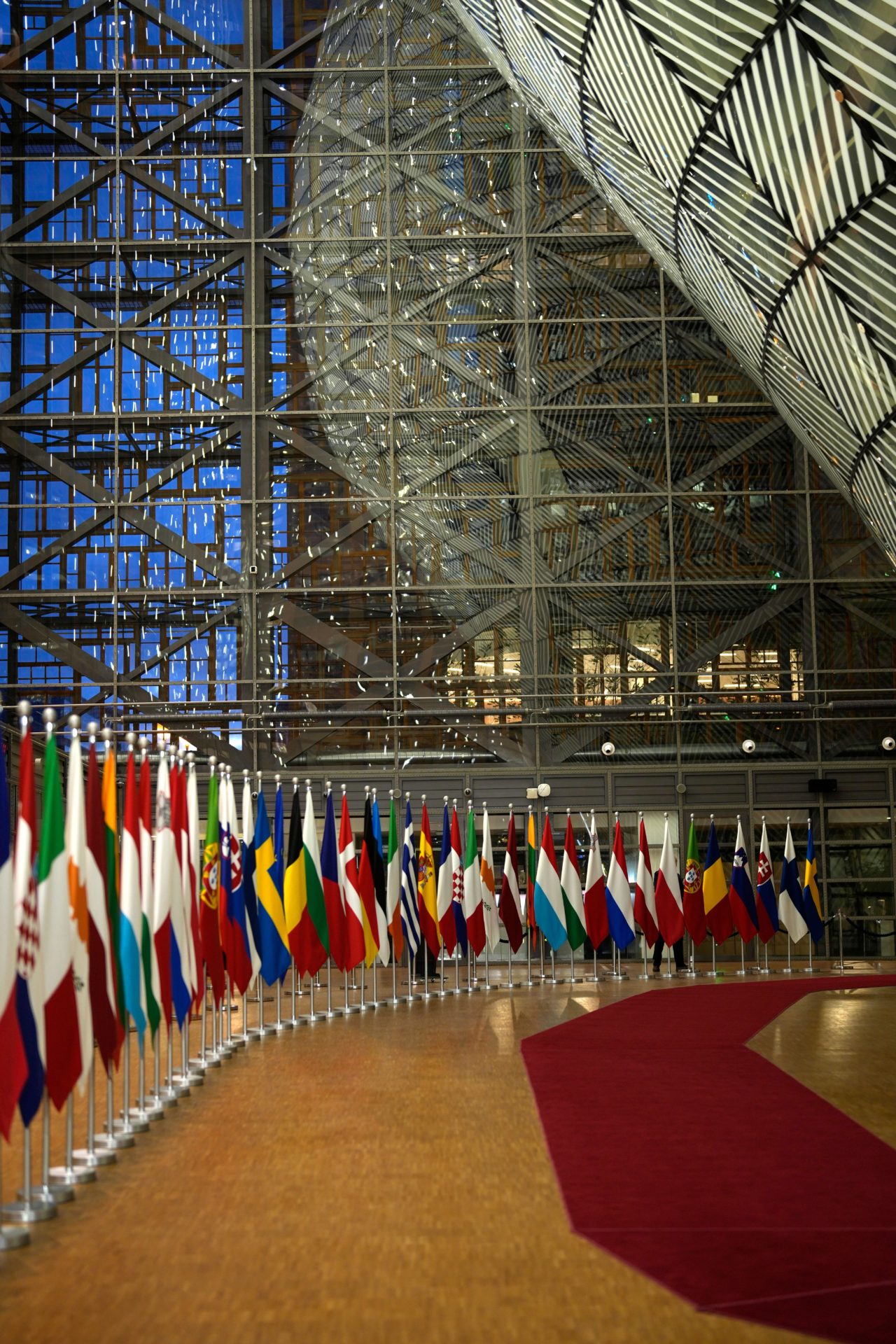 European Union flags line a red carpet at the arrival area during the European Council meeting, 11-12-2023. 