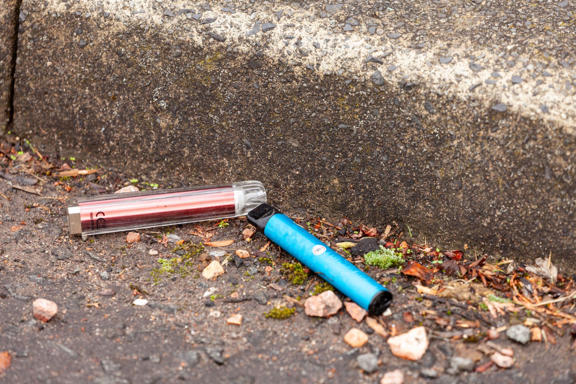 Single use disposable vapes lying discarded on the road