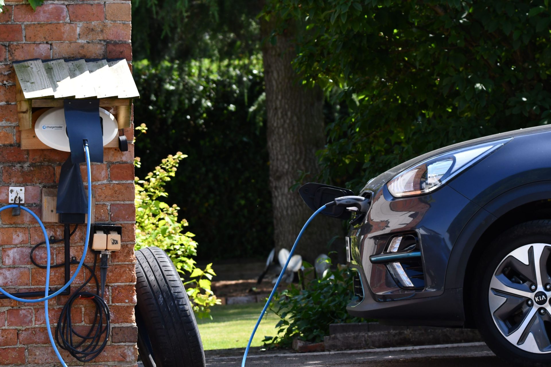 Electric Car Charging, on rural driveway, with a bespoke housing unit for the car charger. EV charging.