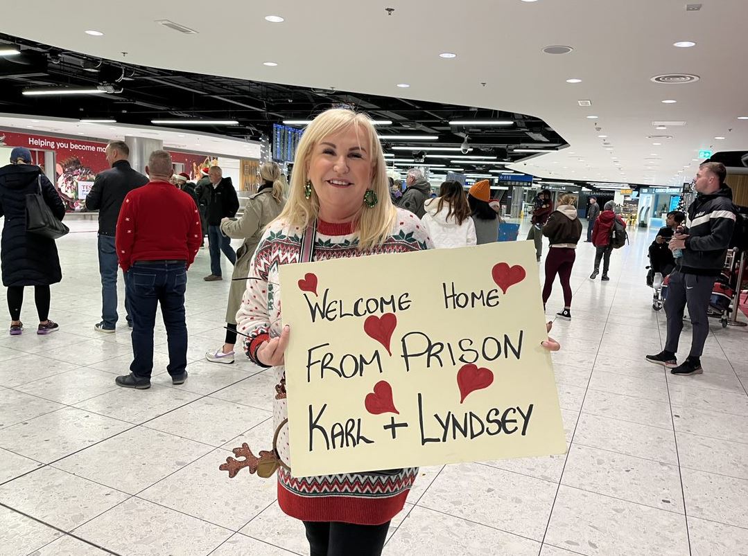 Nora Finn with her sign at Dublin Airport, 22-12-23