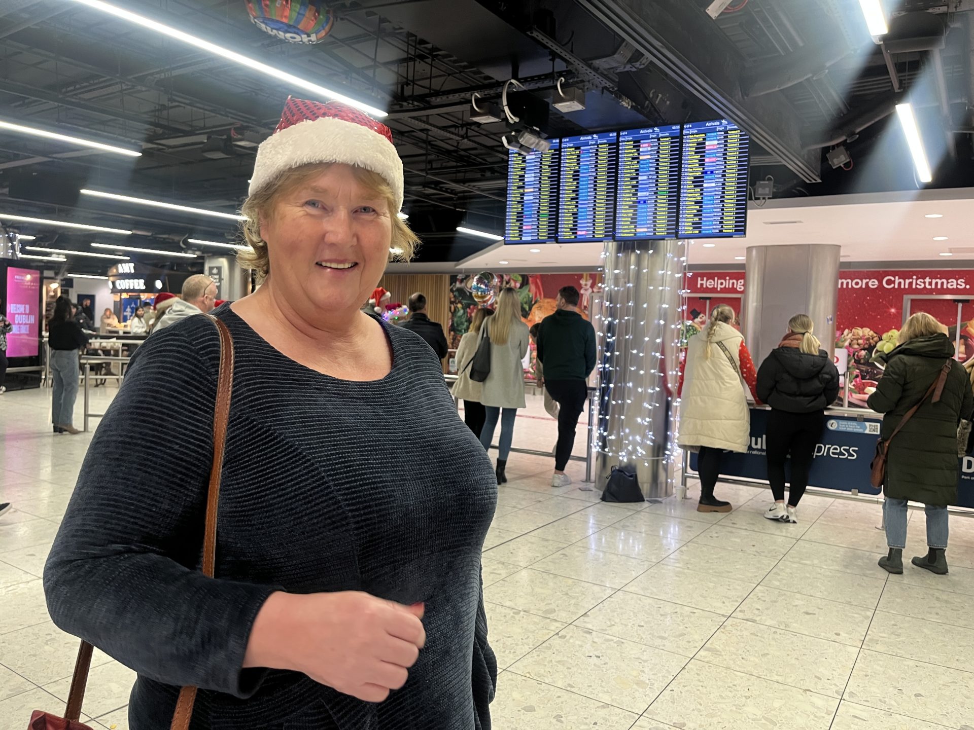 Teresa McDonald looking festive waiting to surprise her son John at Dublin Airport, 22-12-23. 