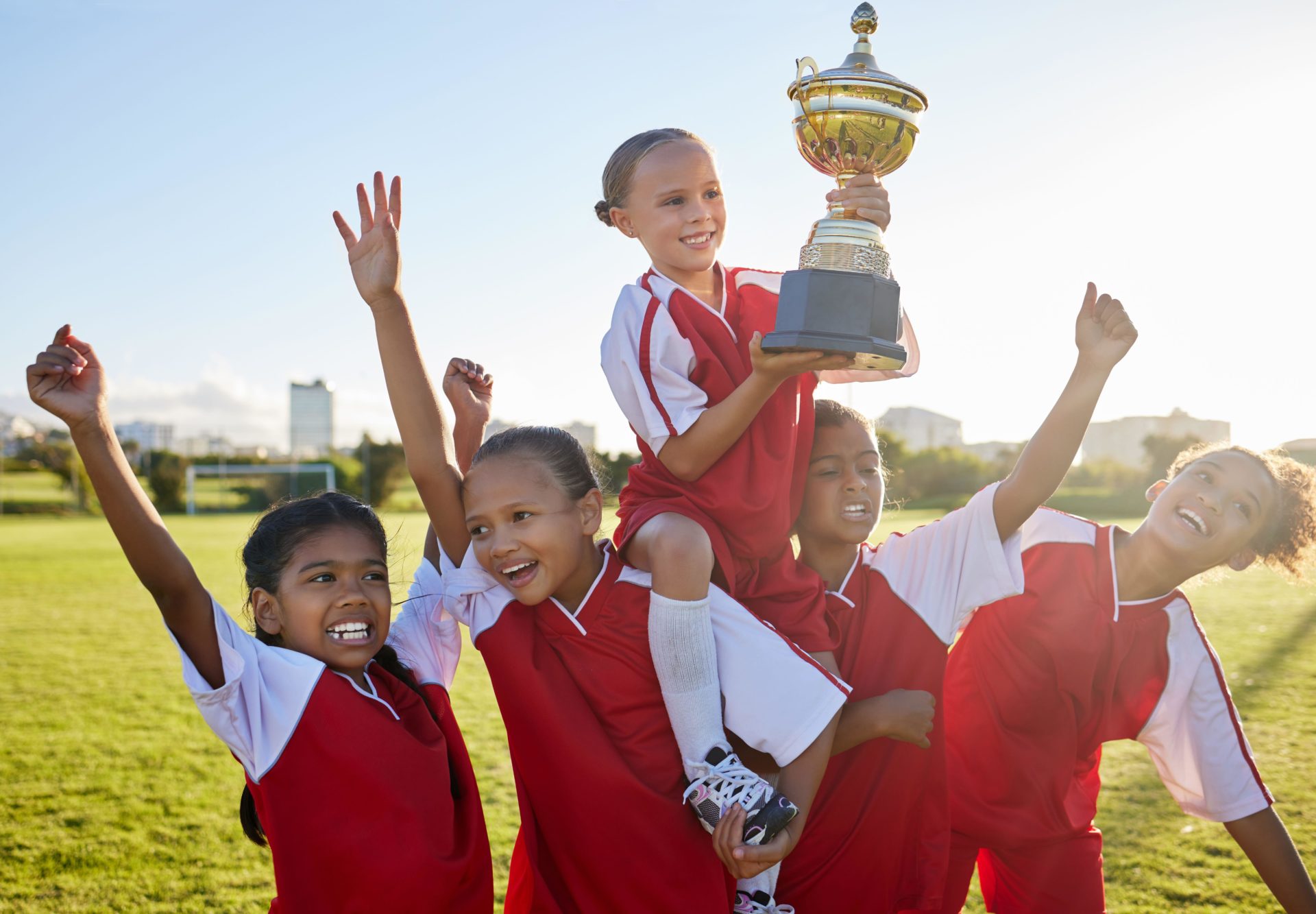 Children winning a trophy for a competition with encouragement from parenting