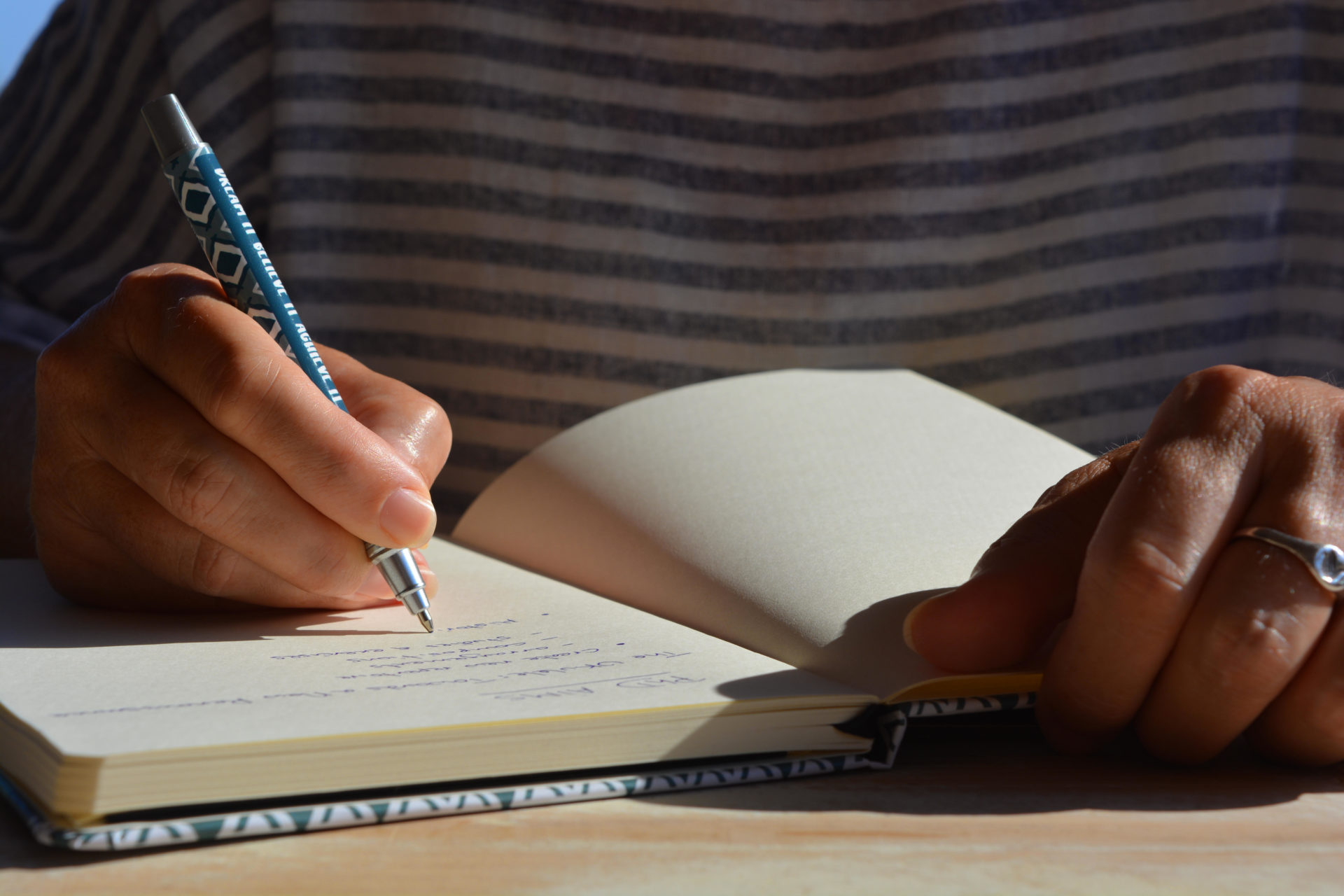 Person writing list of aims in a notebook. Image: Josie Elias / Alamy Stock Photo