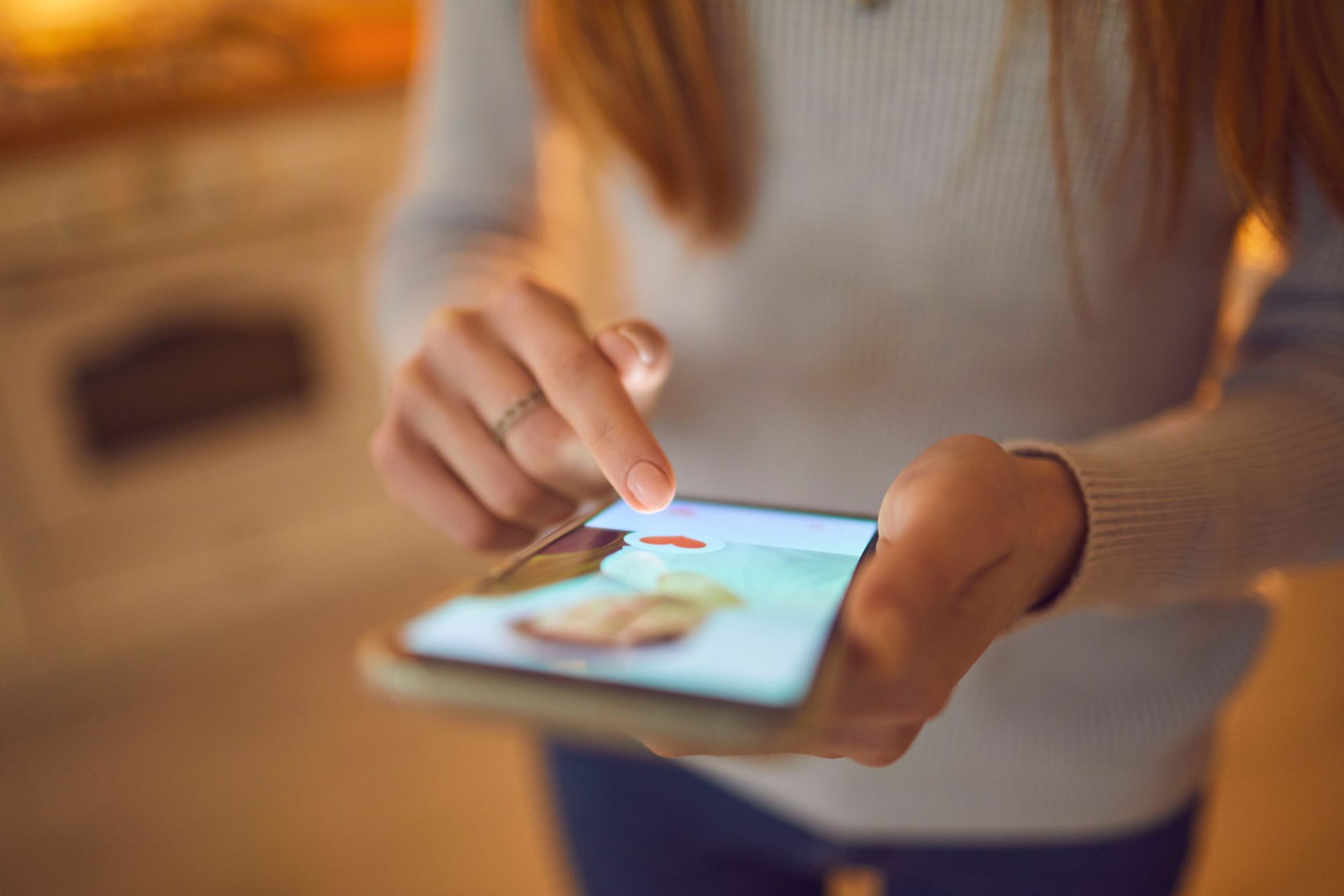 Woman looking at a dating profile picture on an app. Image: Roman Lacheev / Alamy Stock Photo