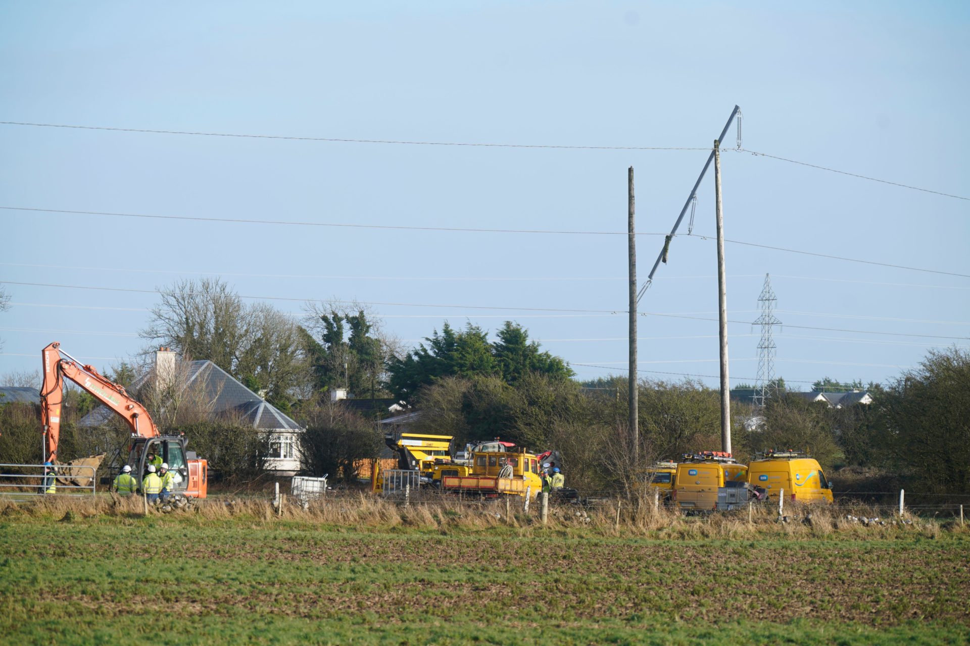 Crews from ESB Networks replace fallen electricity pylons in a field near Galway airport following Storm Isha. Image: PA Images / Alamy Stock Photo