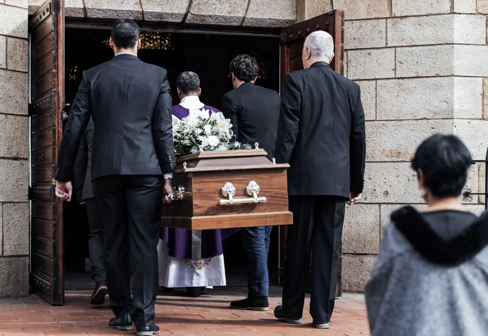 A funeral with a coffin being carried into a church, 19-5-22.