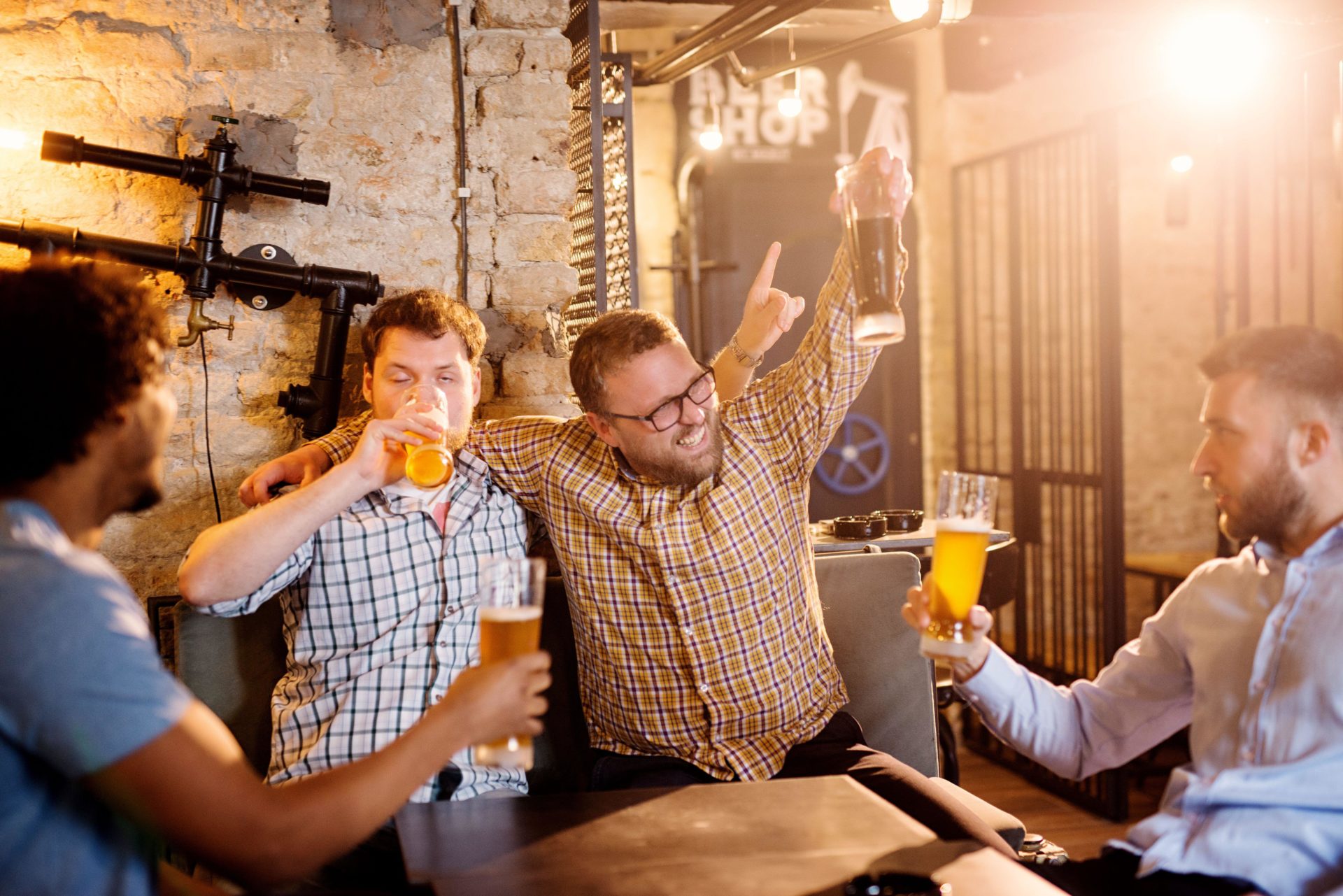 Drunk adult men at a bar drinking. Image: Dusan Petkovic / Alamy Stock Photo